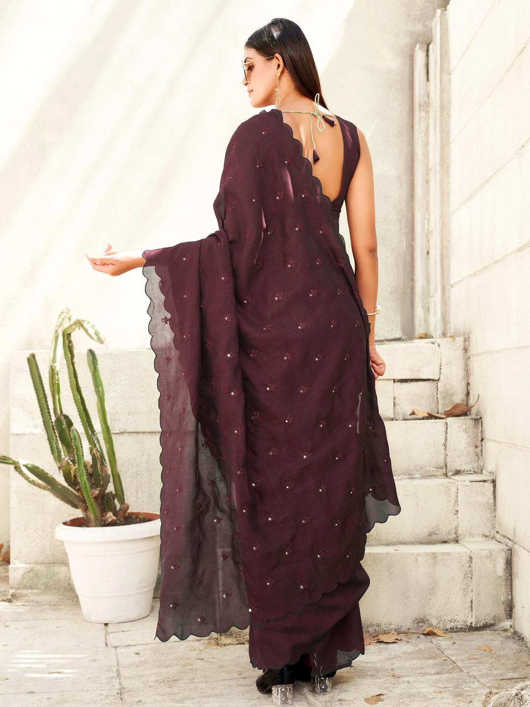 maroon colored saree with mirror embroidery on pallu and scalloped border