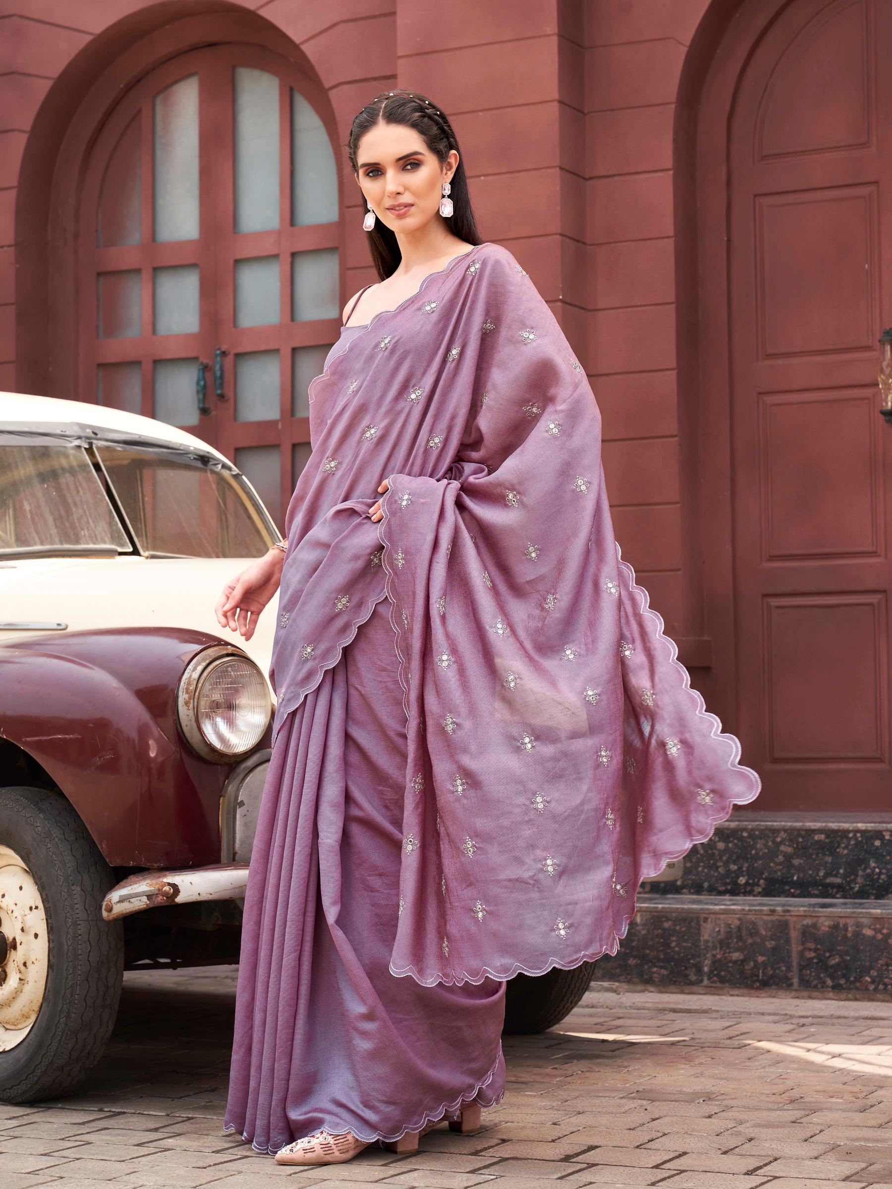 Pink colored saree with mirror embroidery on pallu and scalloped border