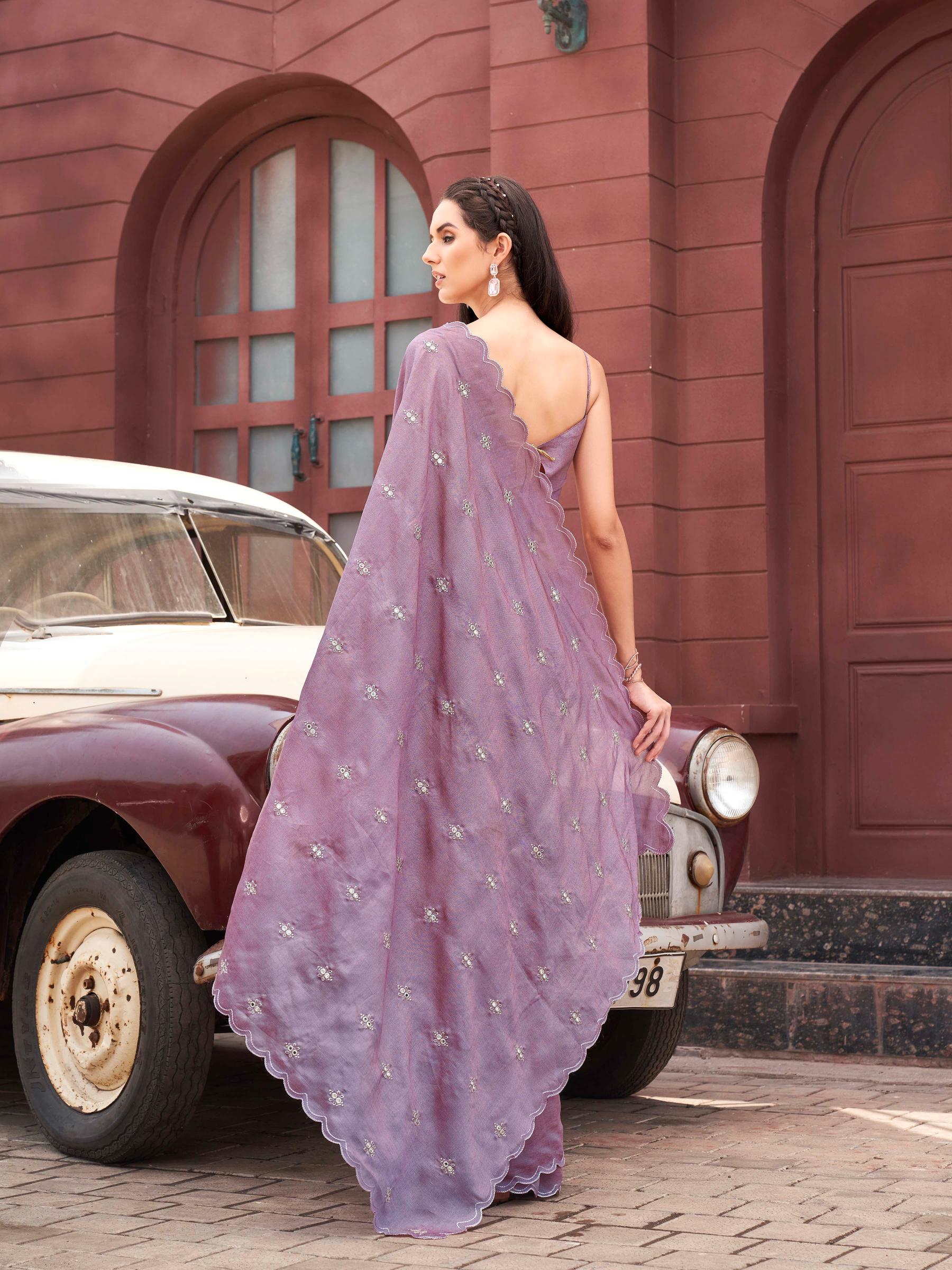 Pink colored saree with mirror embroidery on pallu and scalloped border