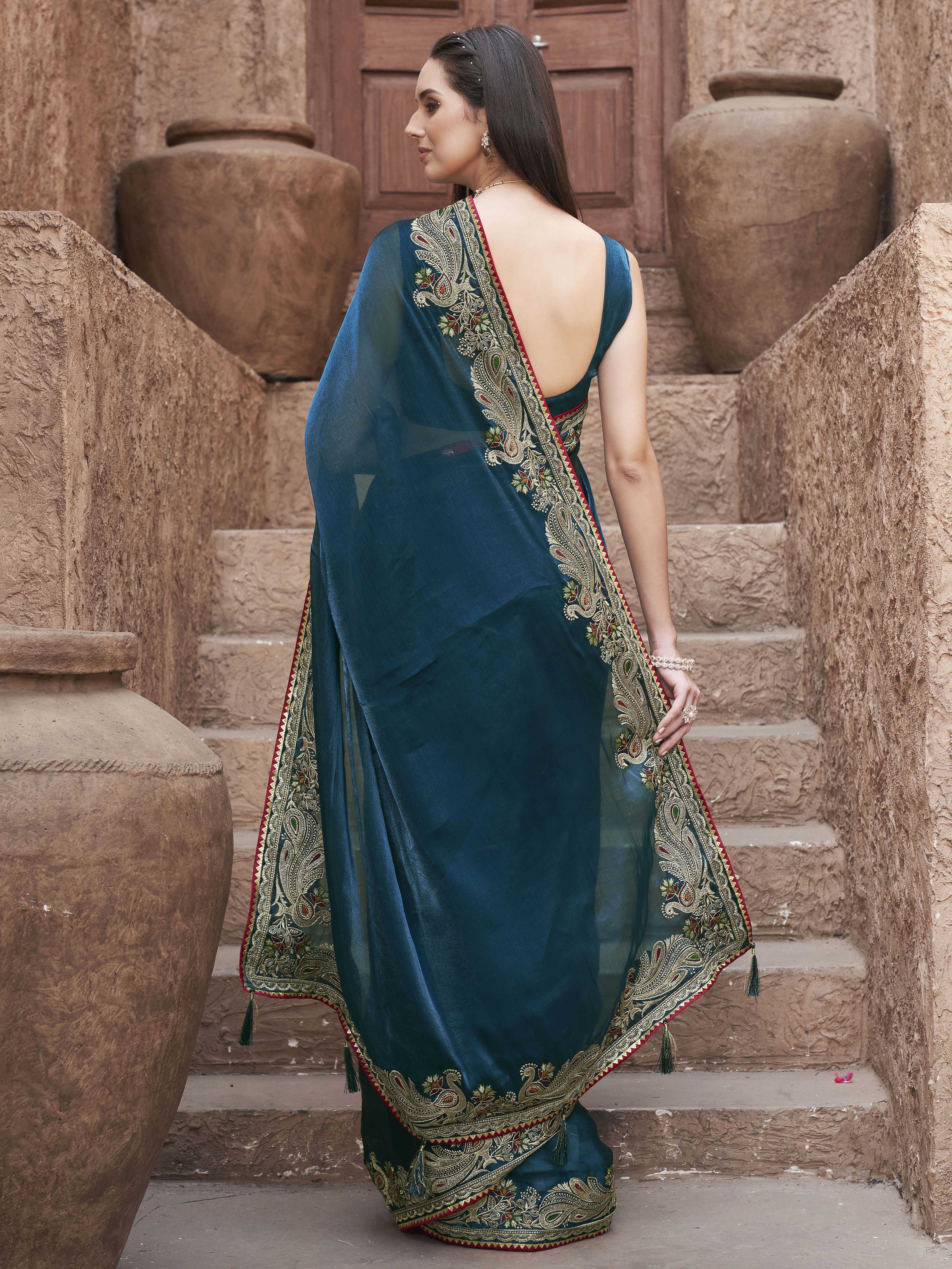 Teal colored zari embroidered saree