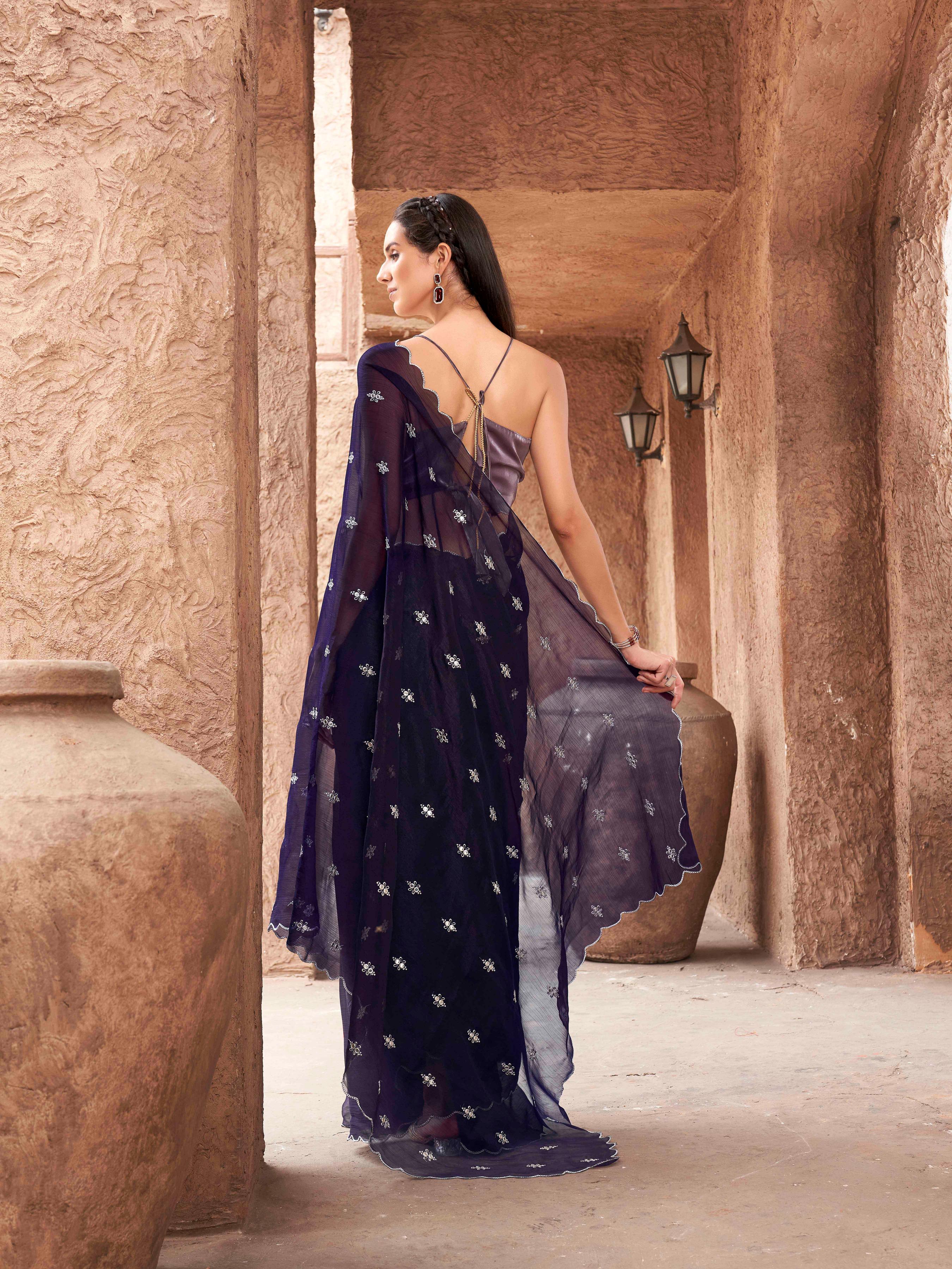 Purple colored saree with mirror embroidery on pallu and scalloped border