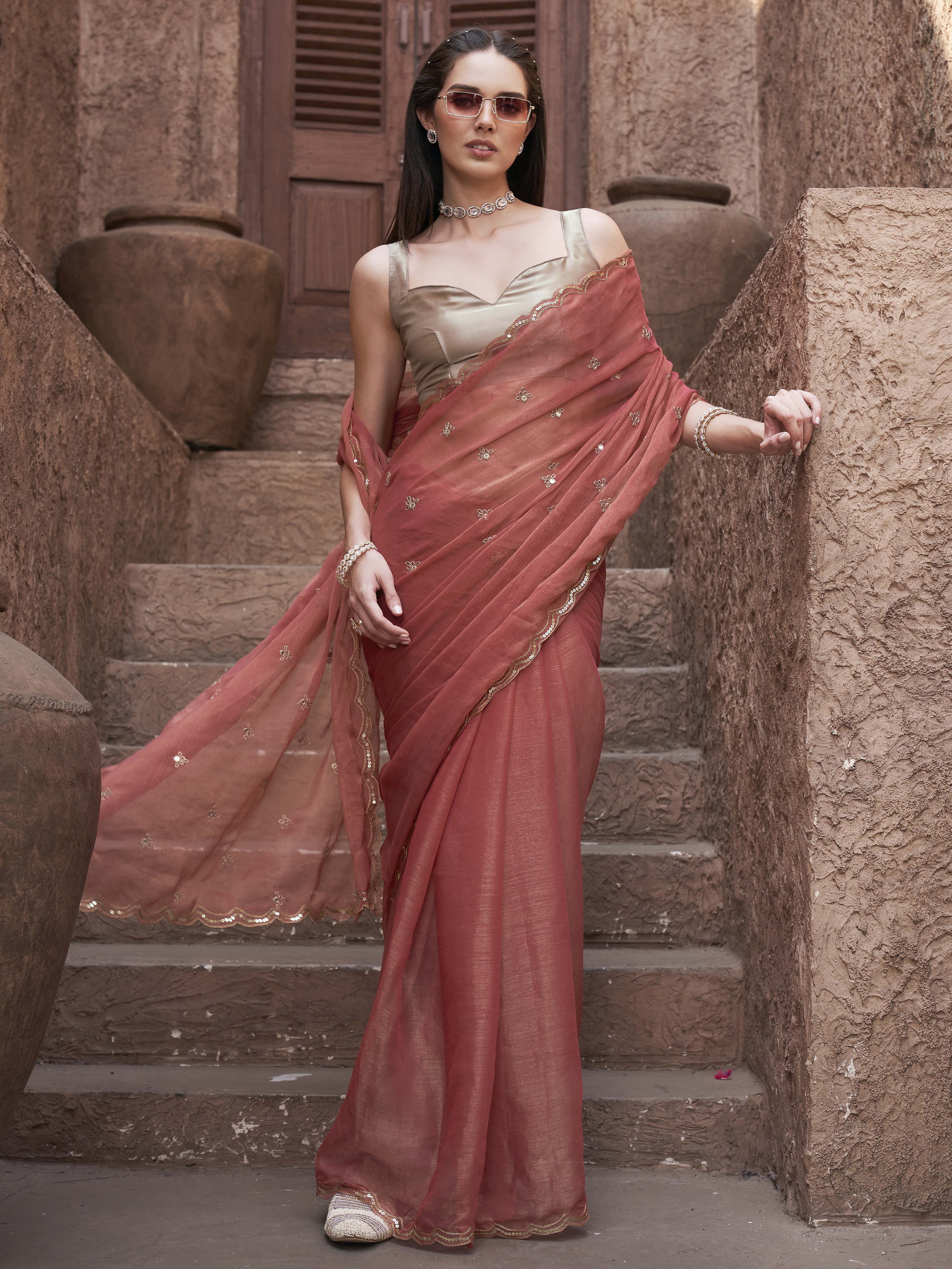 peach colored saree with mirror embroidery on pallu and scalloped border