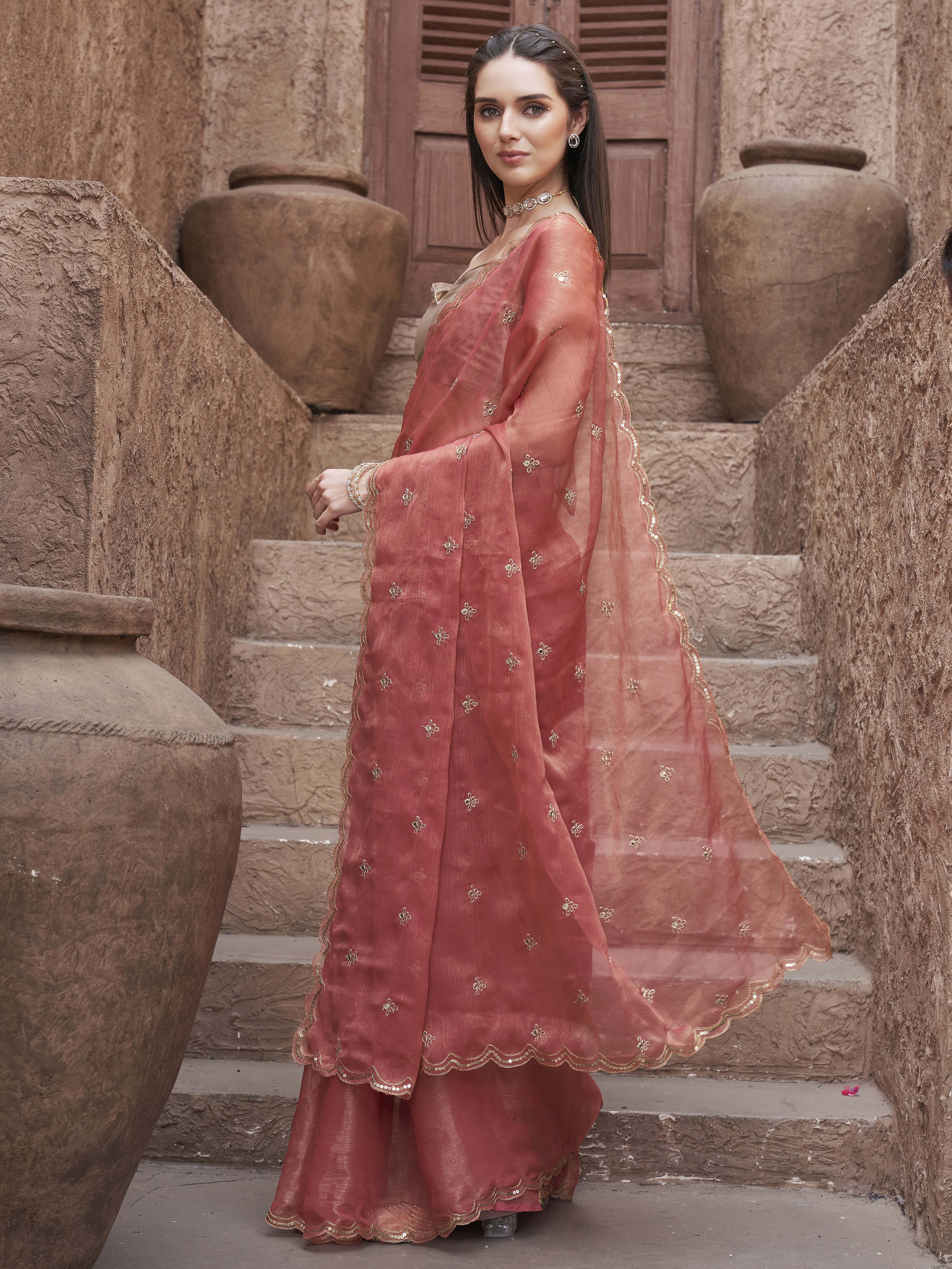 peach colored saree with mirror embroidery on pallu and scalloped border