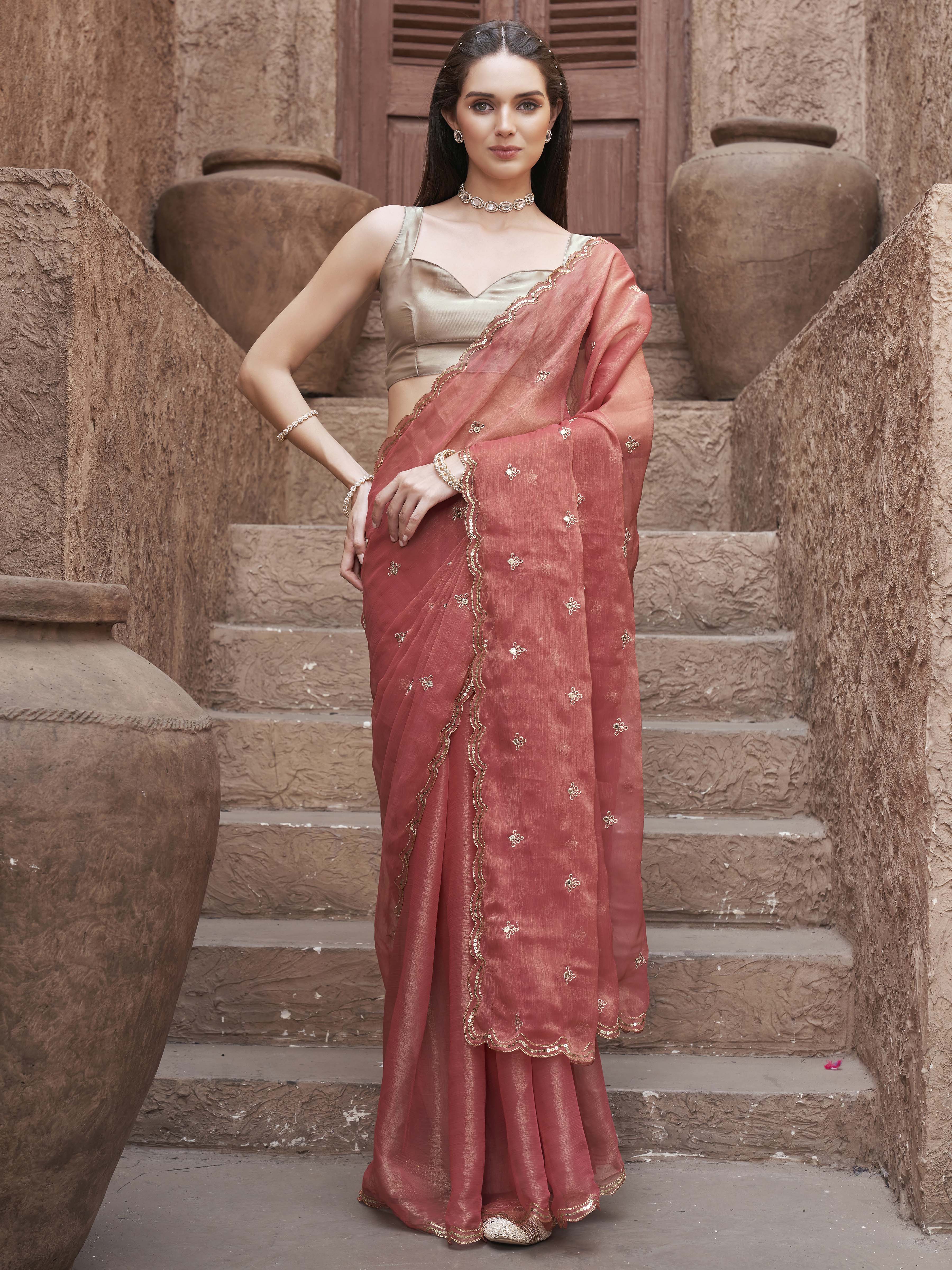 peach colored saree with mirror embroidery on pallu and scalloped border