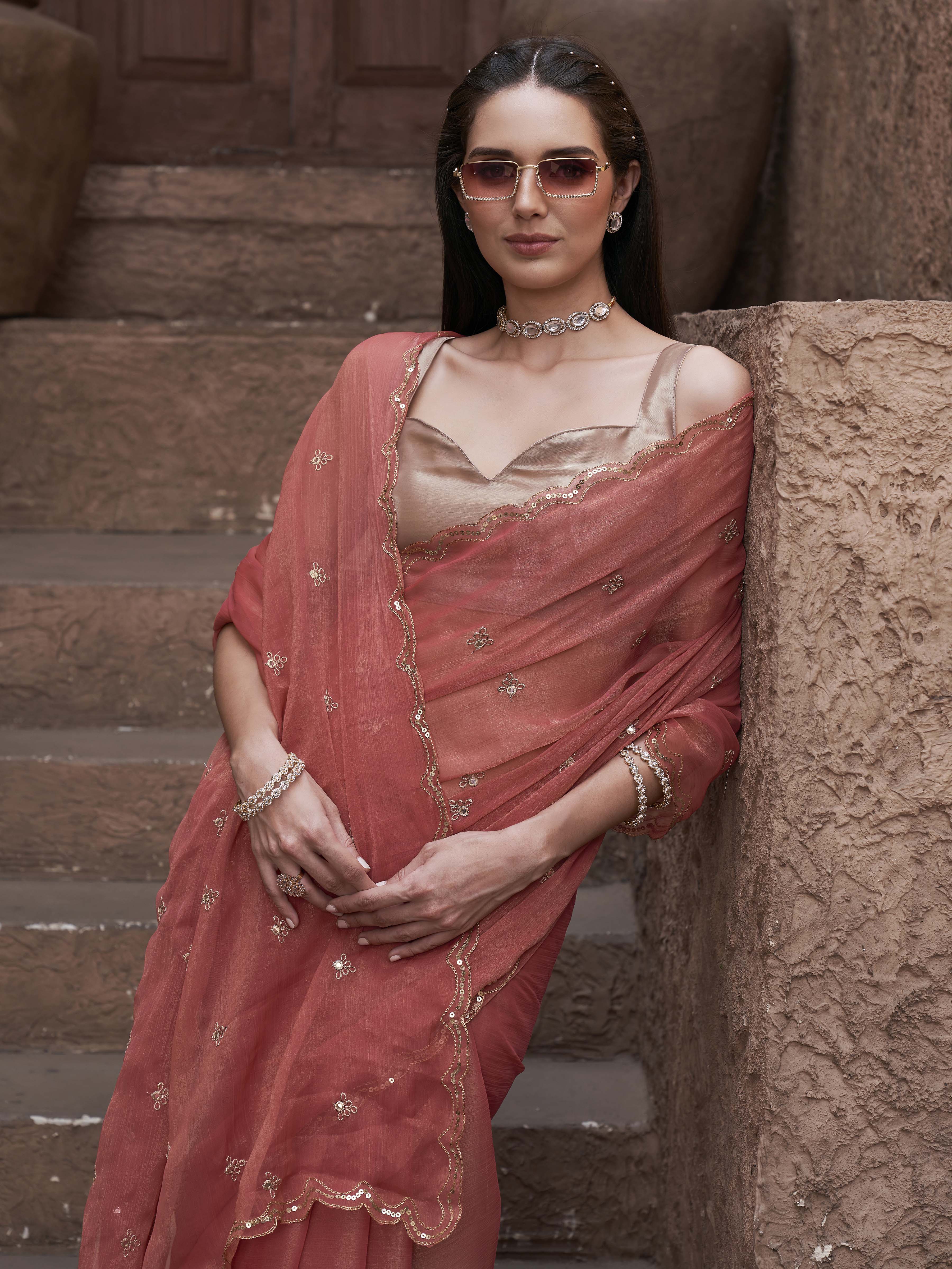peach colored saree with mirror embroidery on pallu and scalloped border