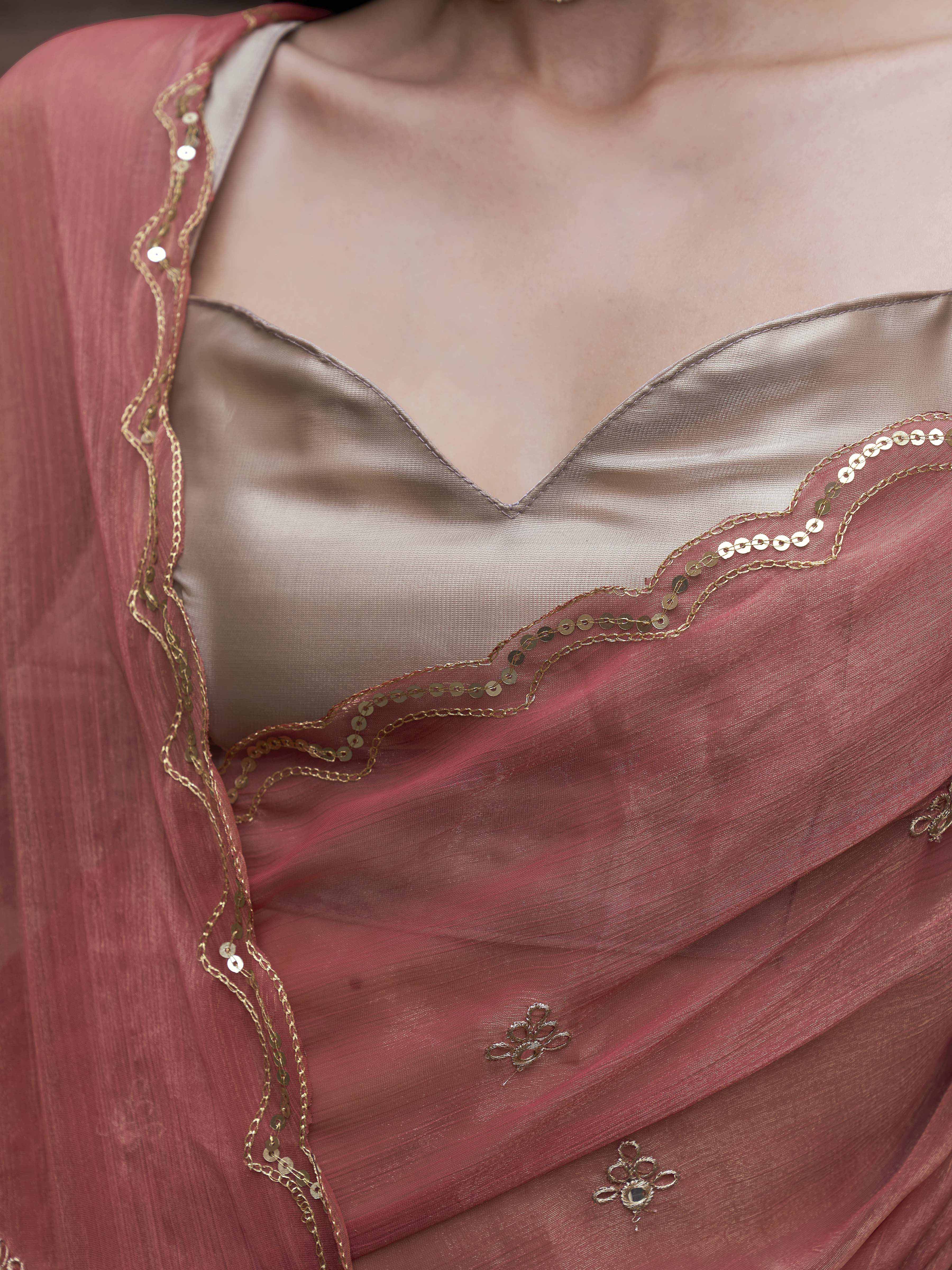 peach colored saree with mirror embroidery on pallu and scalloped border