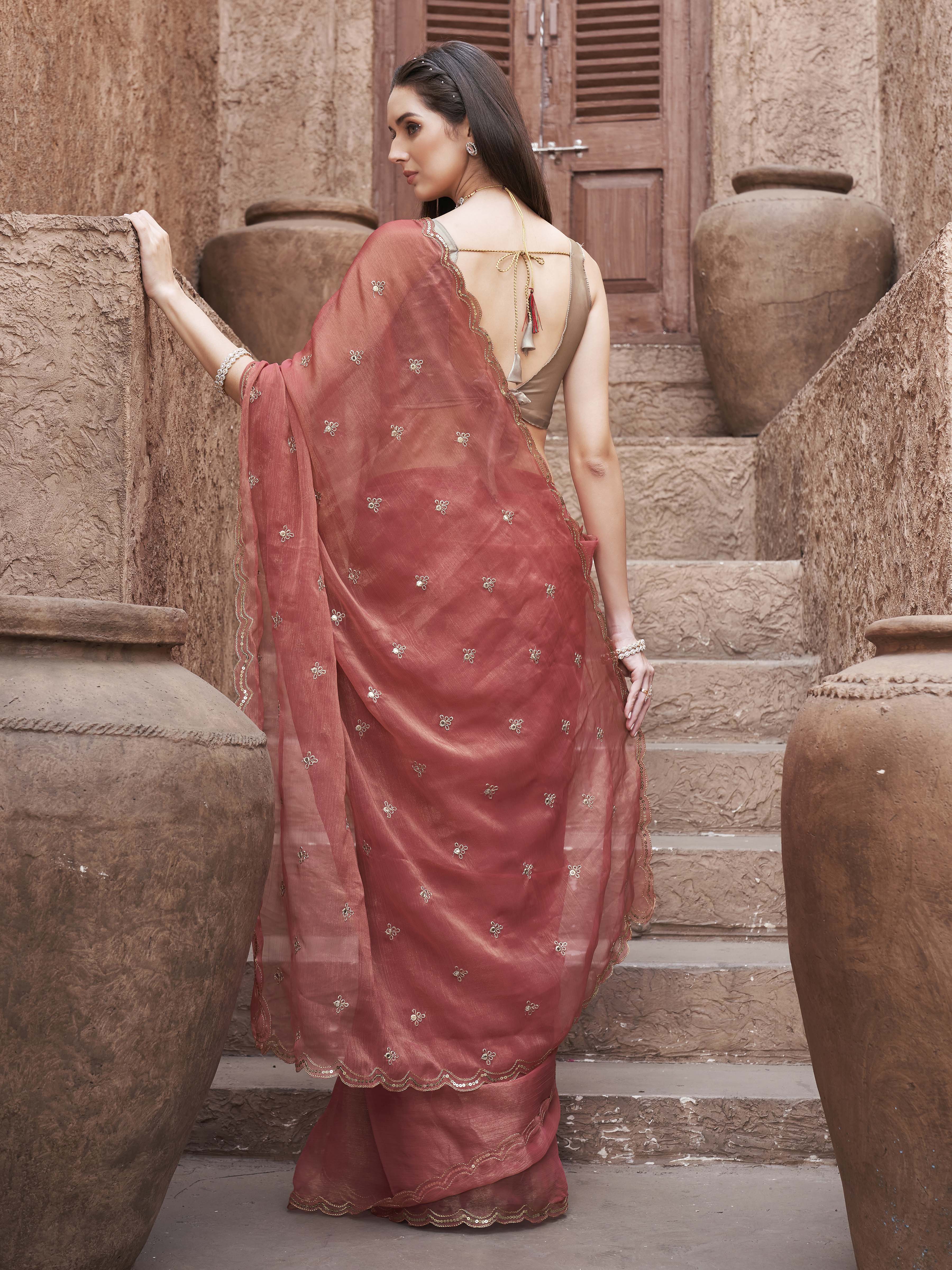 peach colored saree with mirror embroidery on pallu and scalloped border