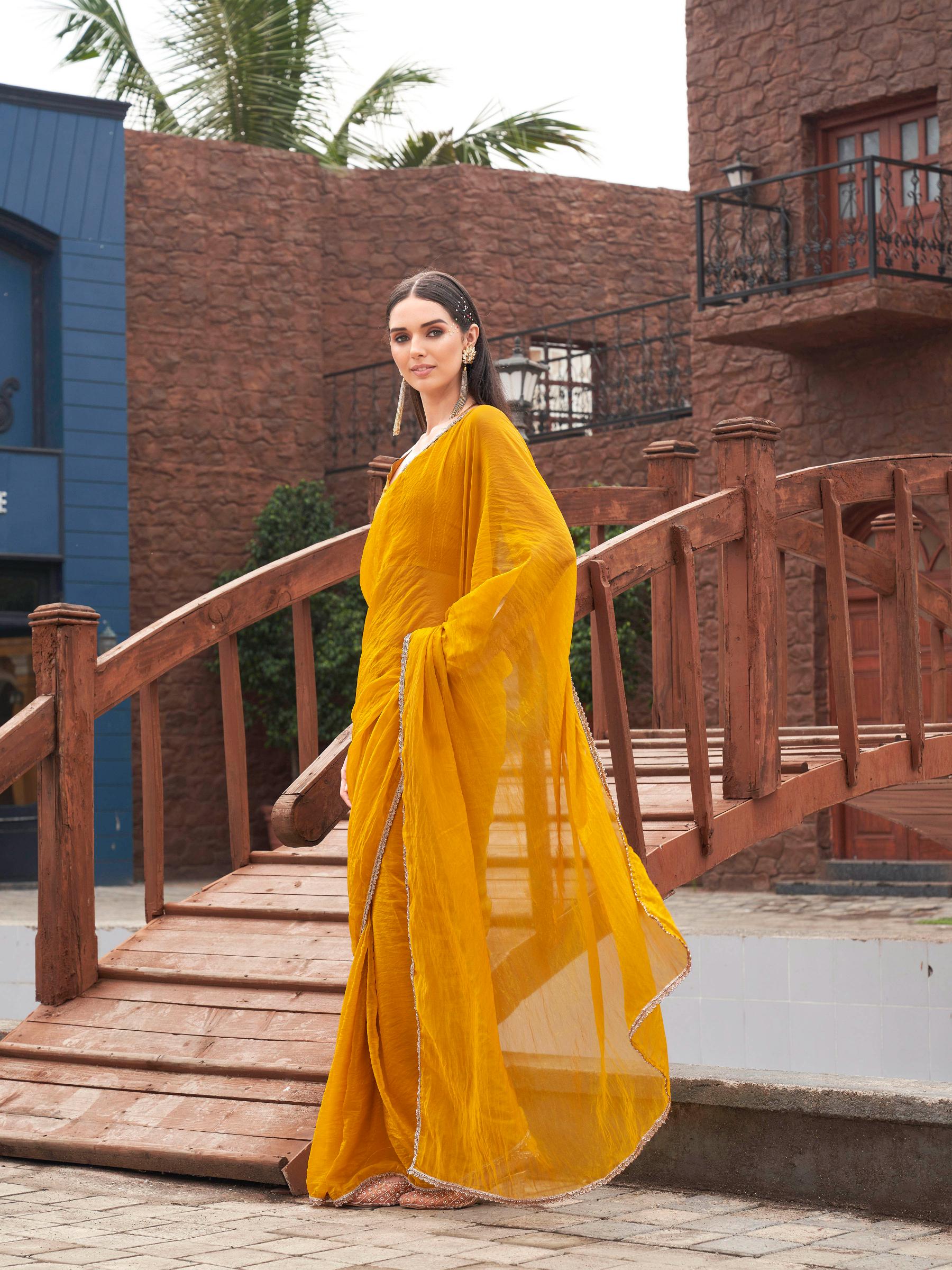 Mustard colored crunchy saree with embellished lace and brocade blouse