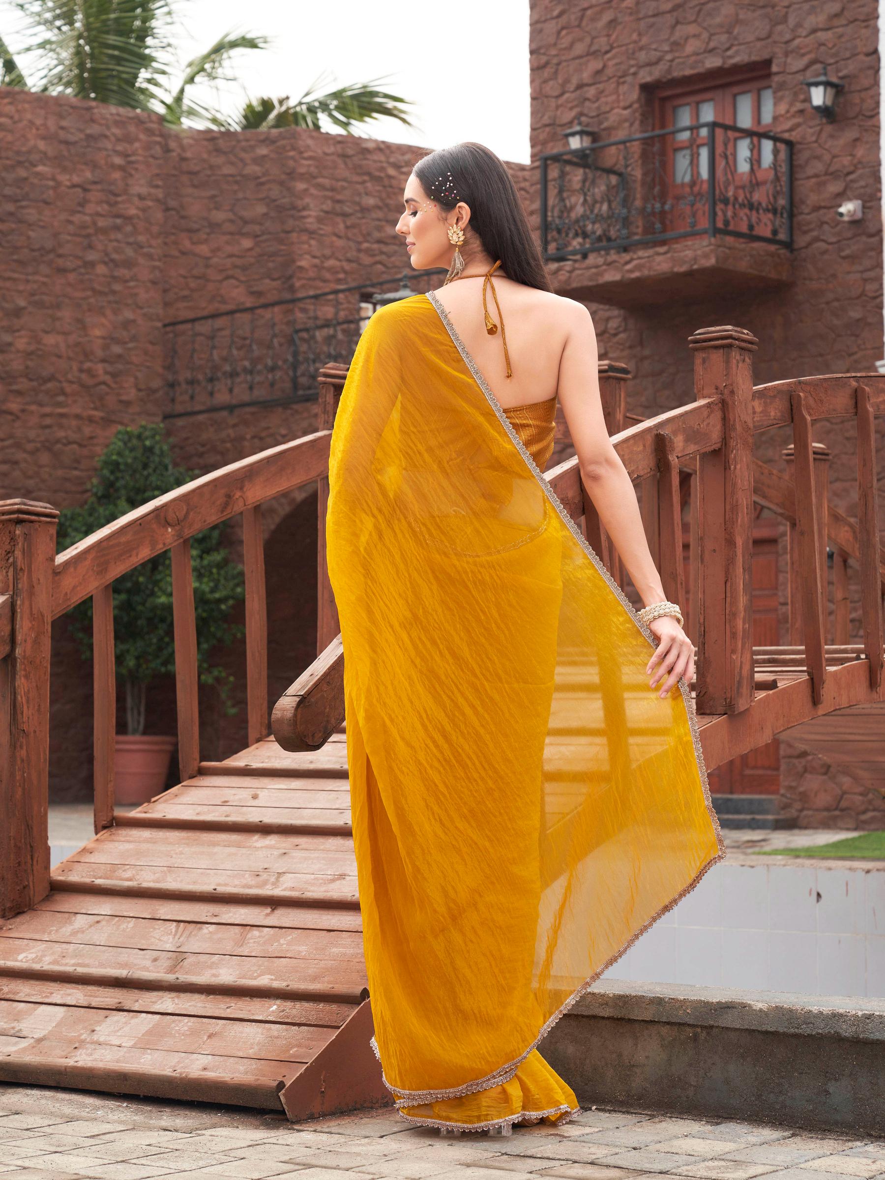 Mustard colored crunchy saree with embellished lace and brocade blouse