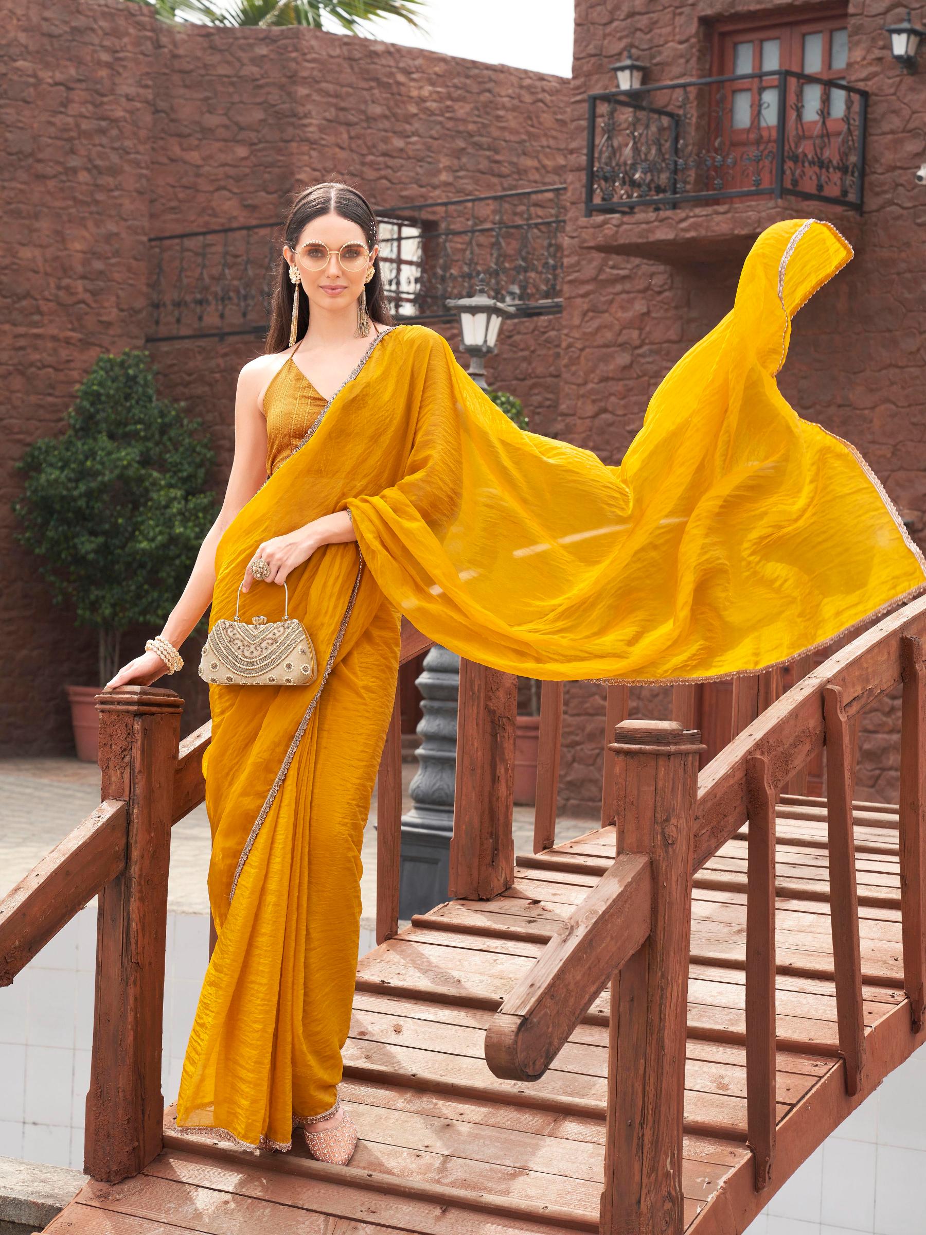 Mustard colored crunchy saree with embellished lace and brocade blouse