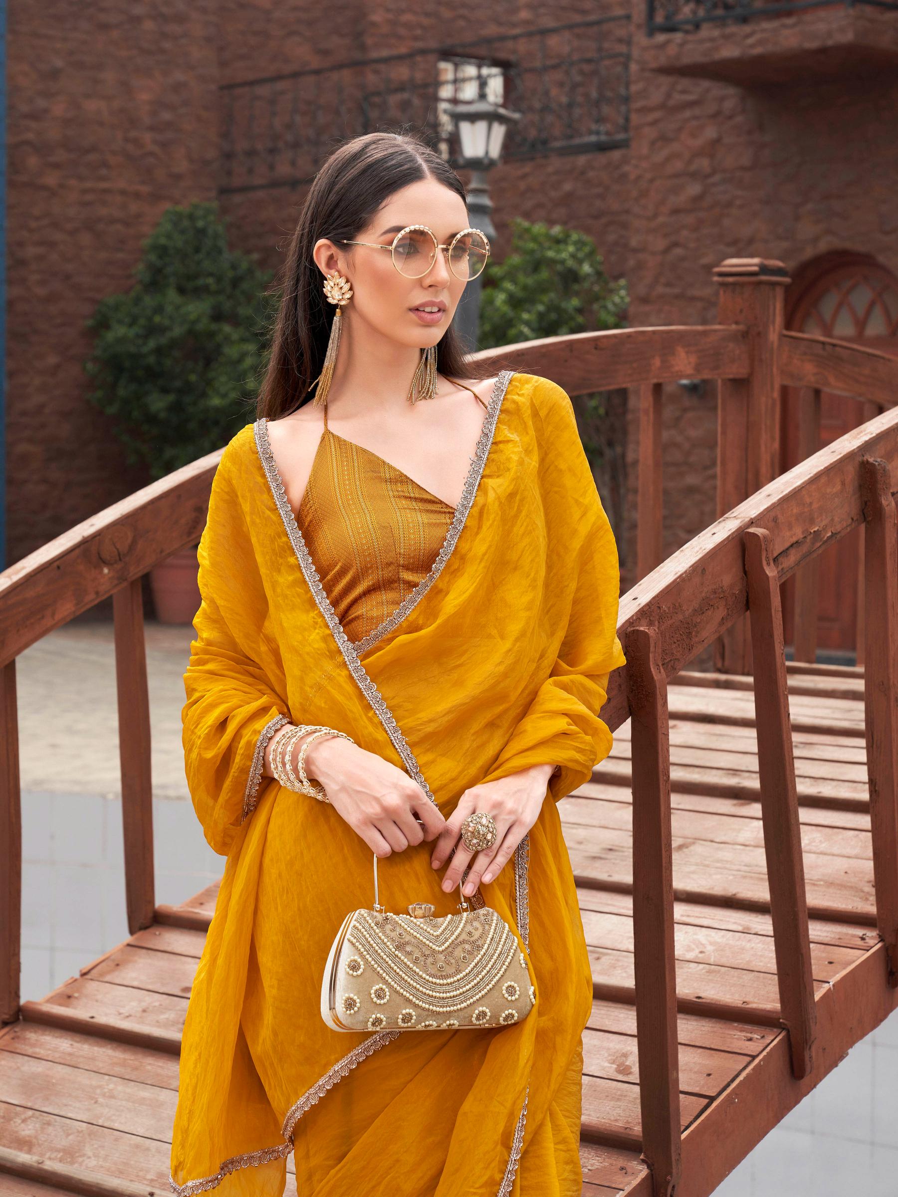 Mustard colored crunchy saree with embellished lace and brocade blouse