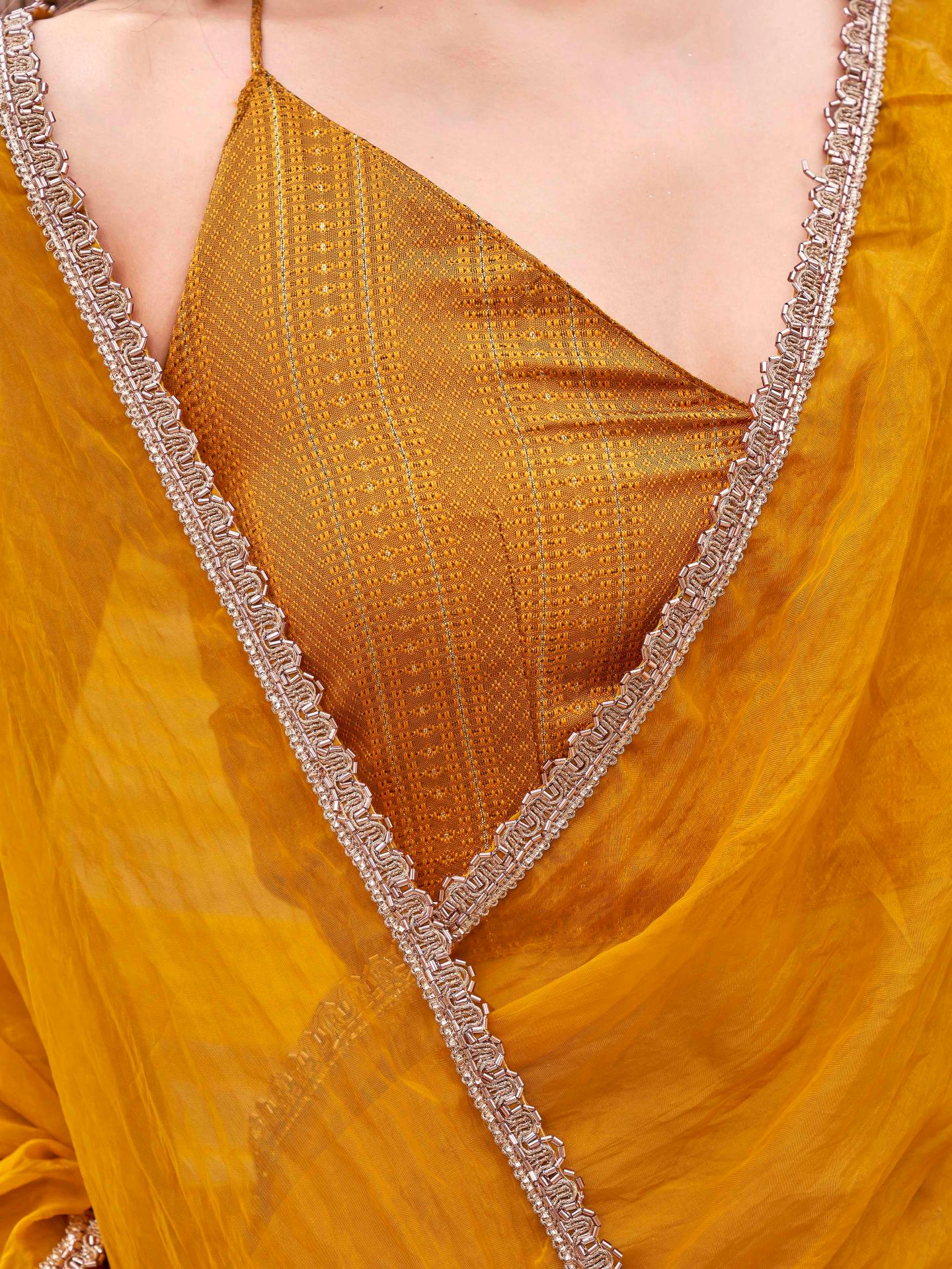 Mustard colored crunchy saree with embellished lace and brocade blouse