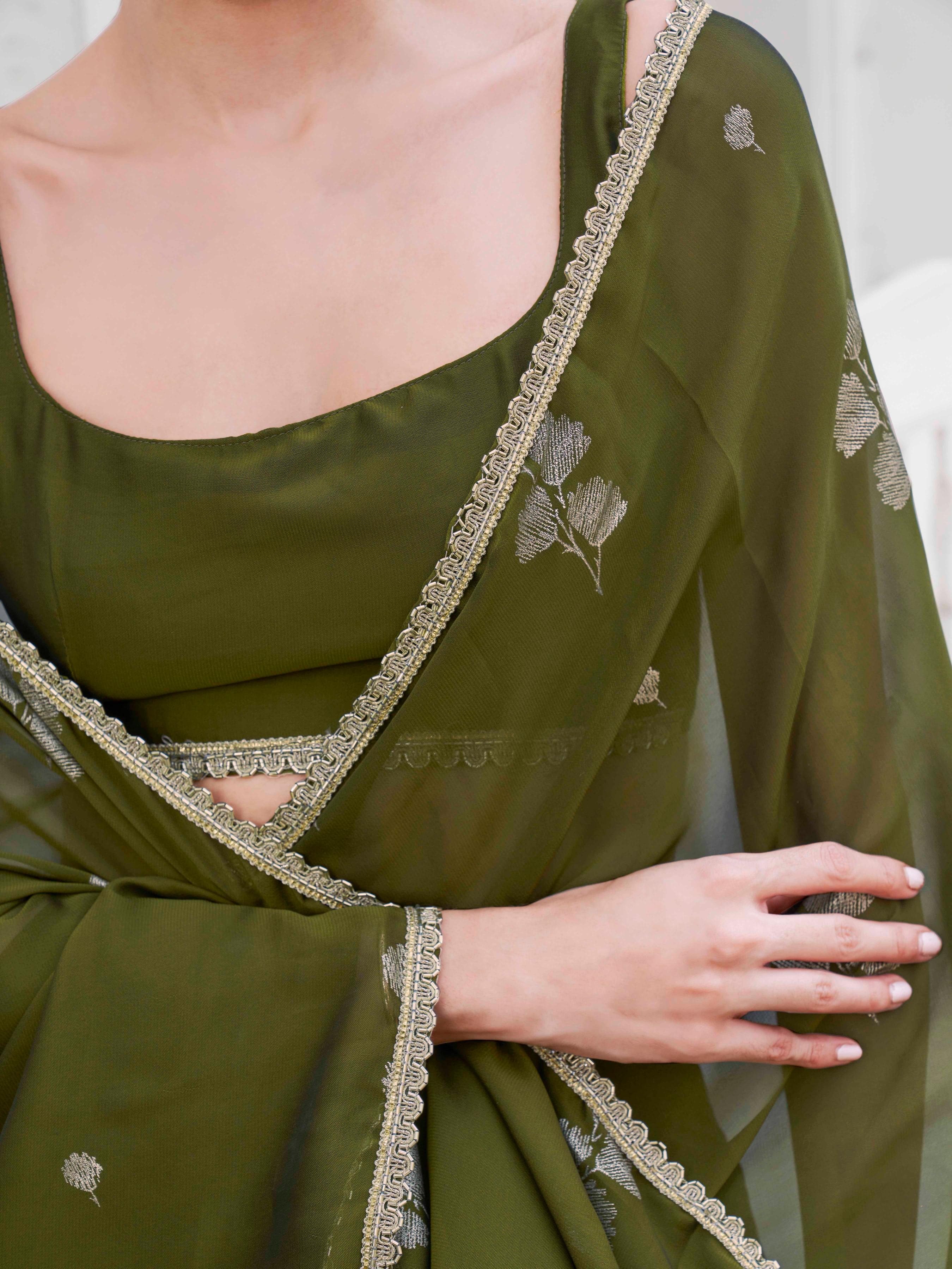 Mehendi green colored designer saree with foil embellishment and embellished lace