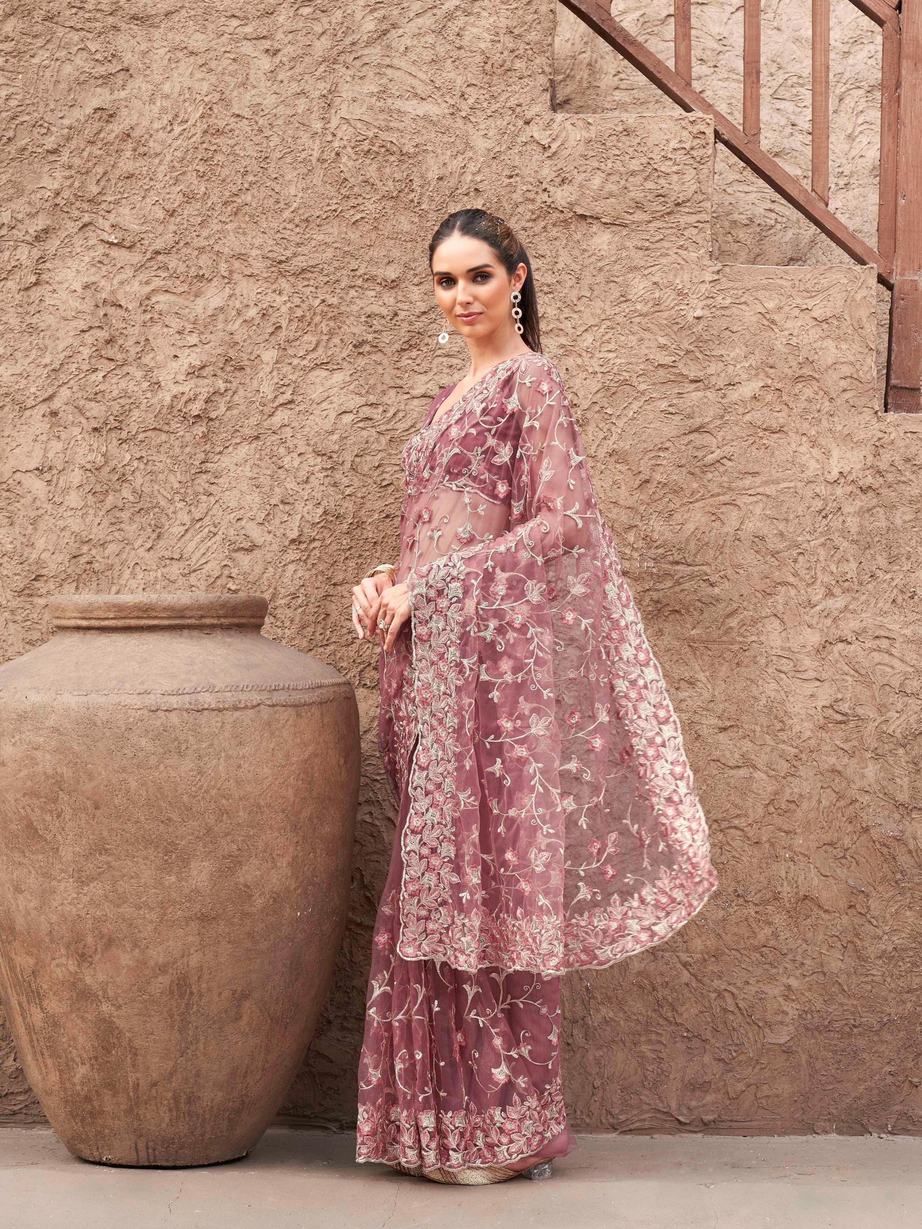 Pink colored embroidered net saree