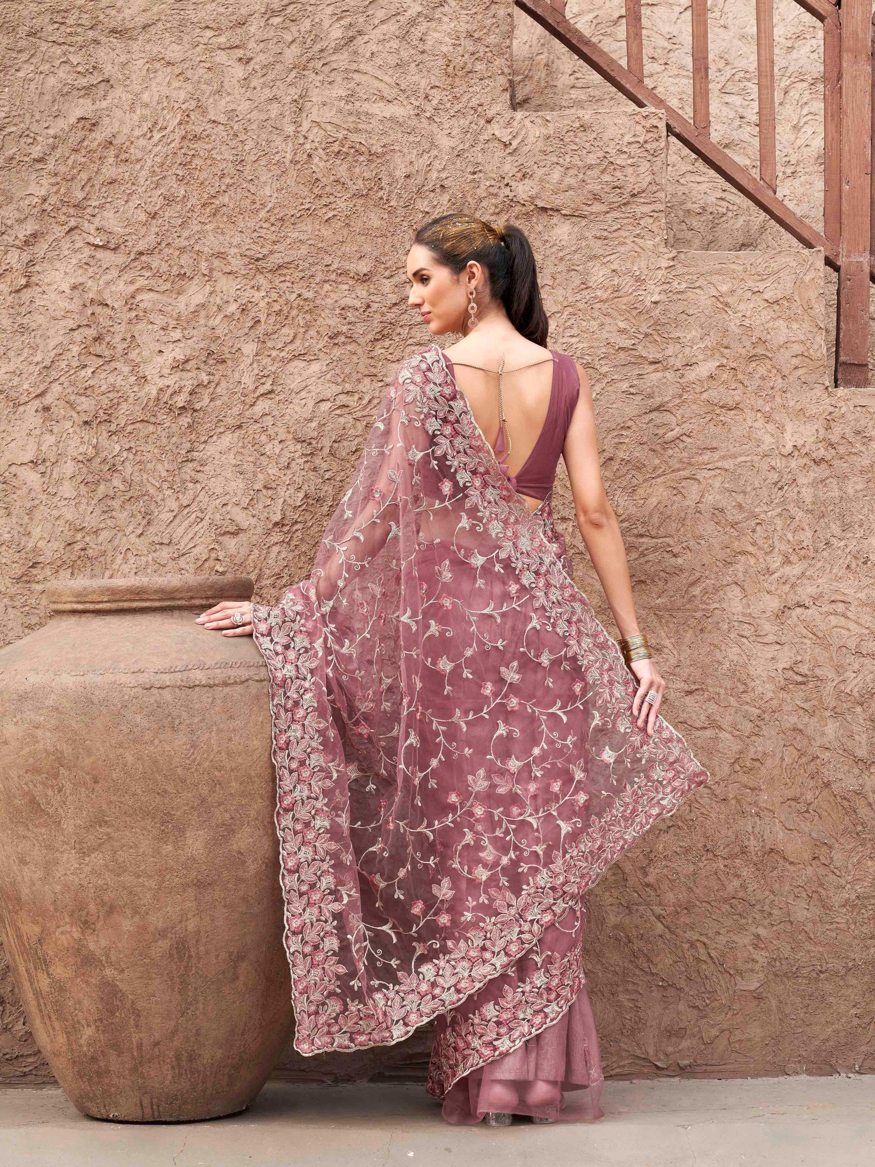 Pink colored embroidered net saree
