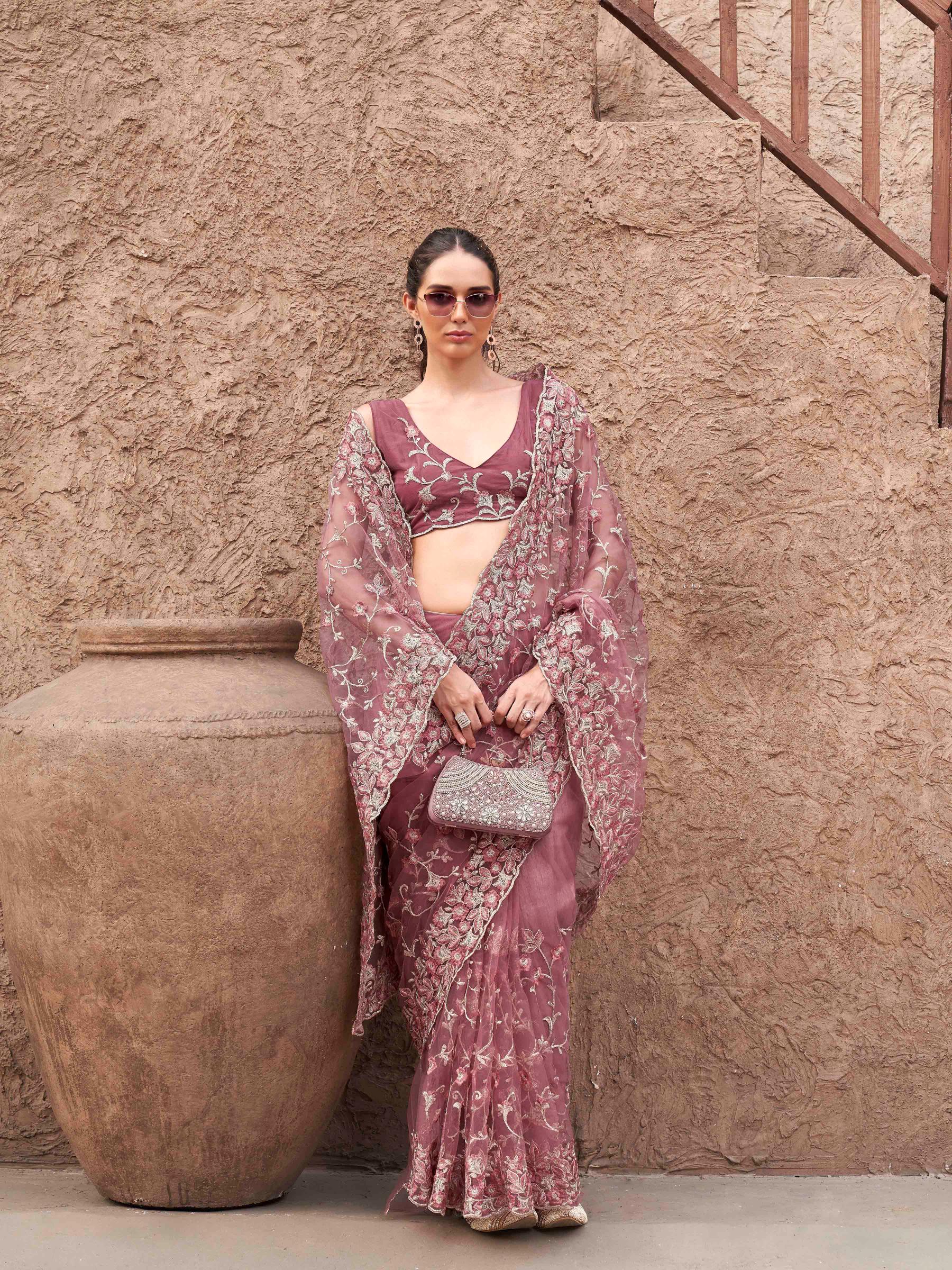 Pink colored embroidered net saree