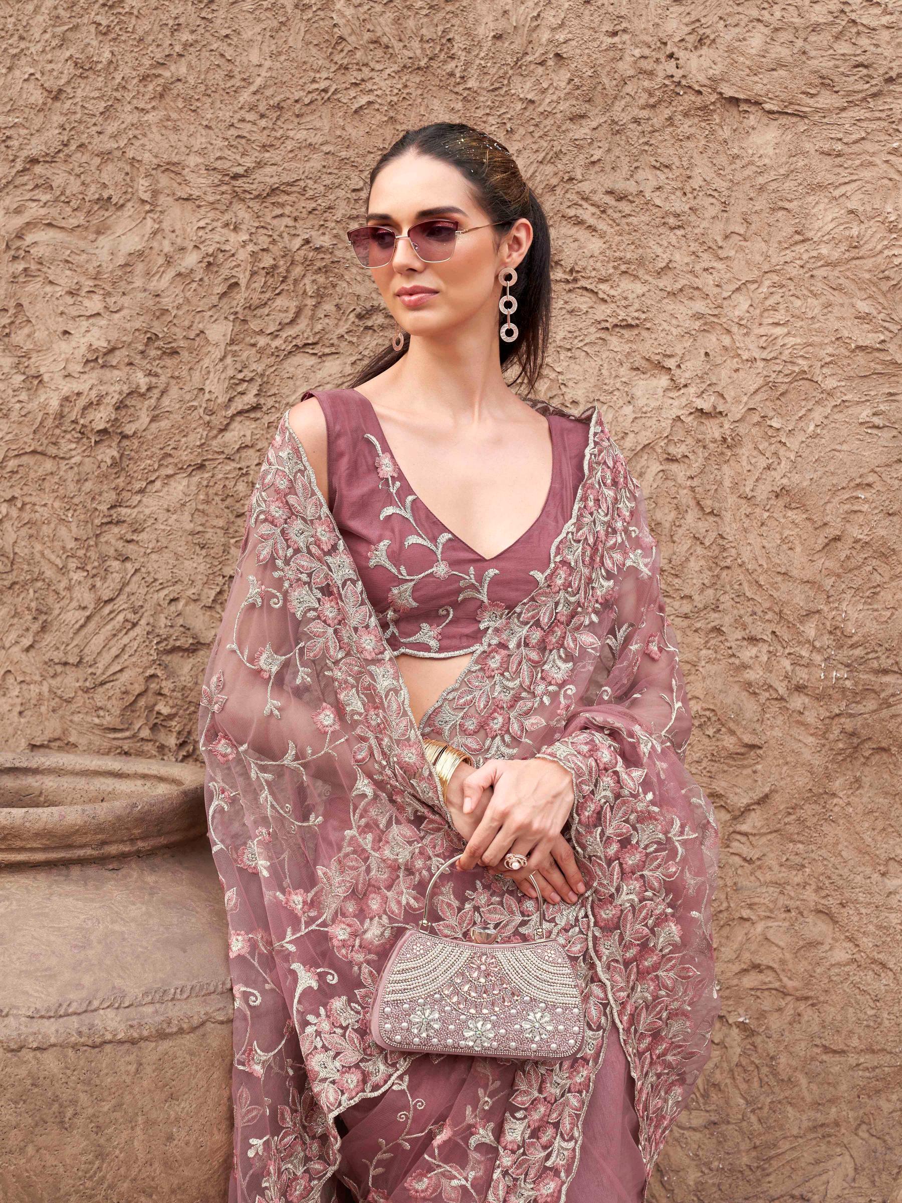 Pink colored embroidered net saree