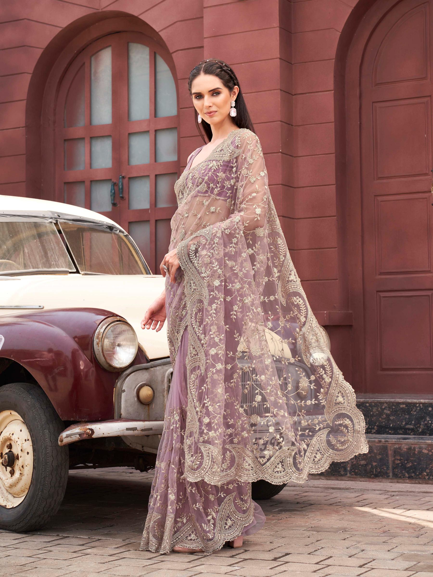 Pink colored embroidered net saree