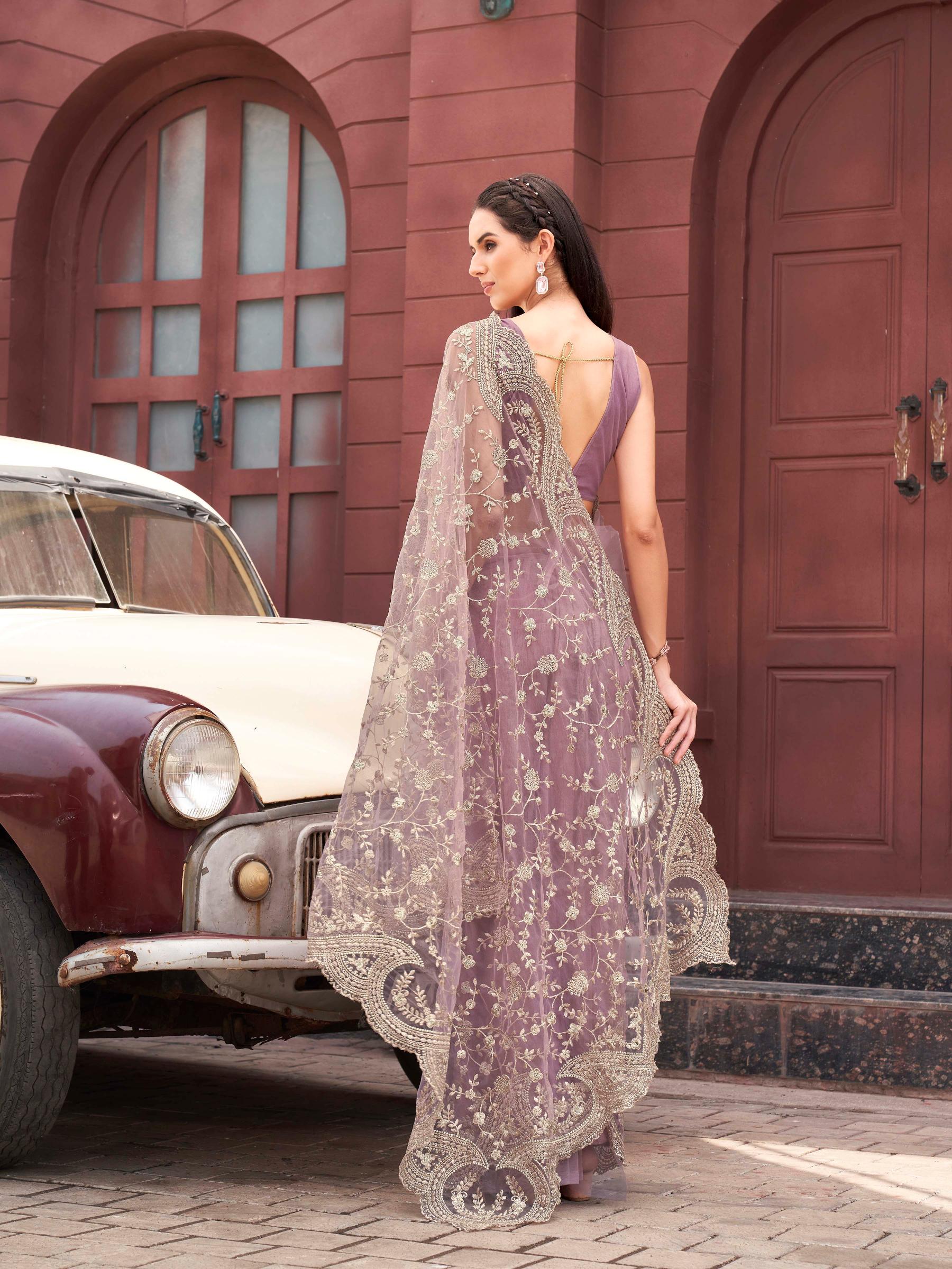 Pink colored embroidered net saree