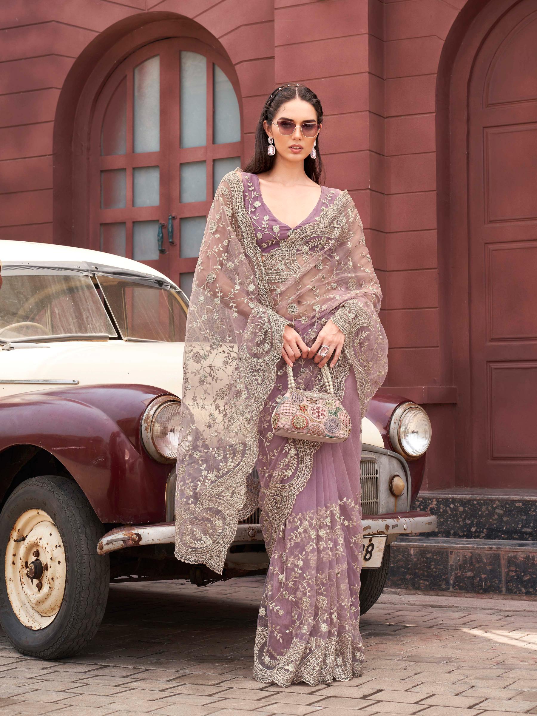 Pink colored embroidered net saree