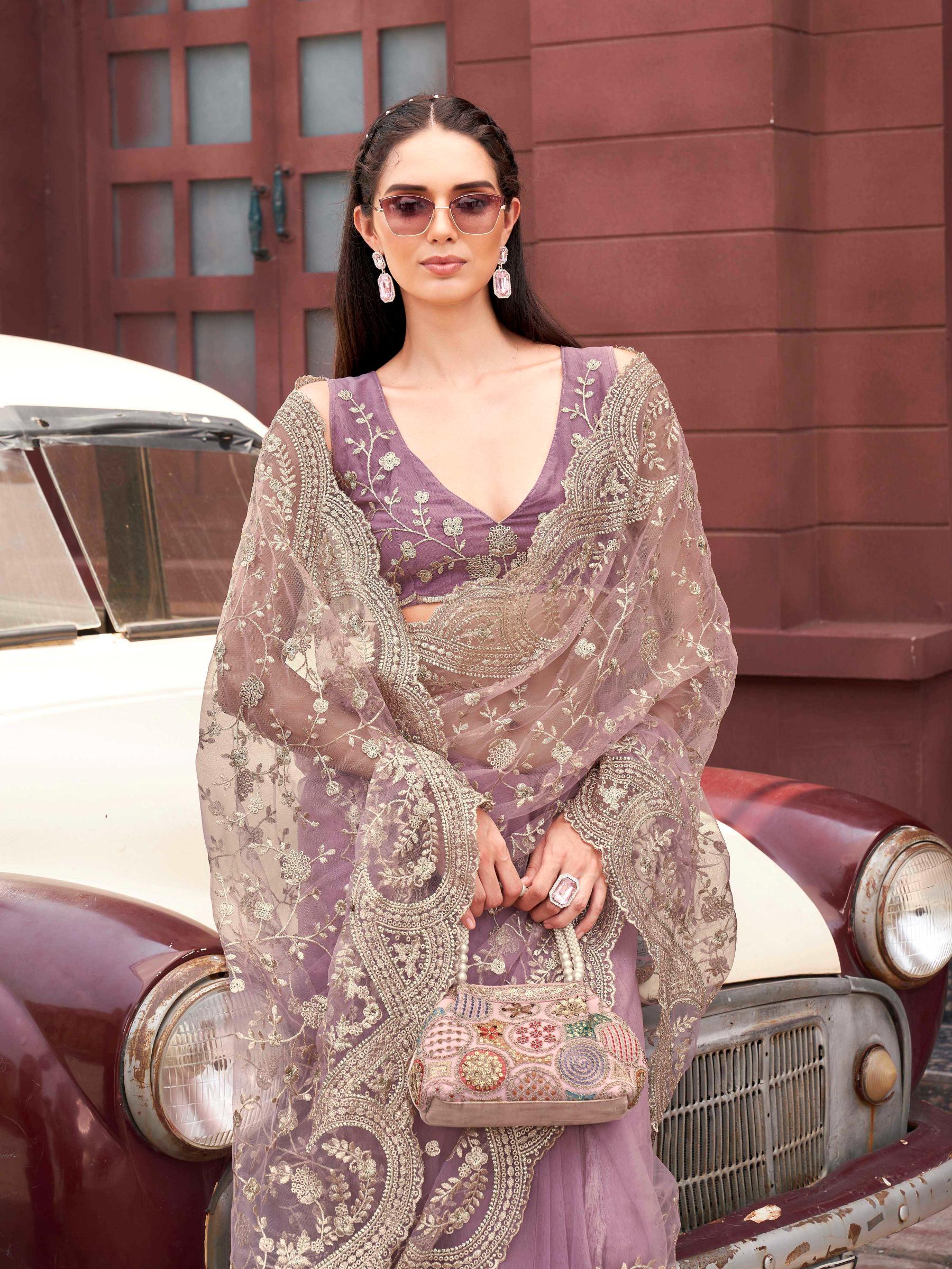 Pink colored embroidered net saree