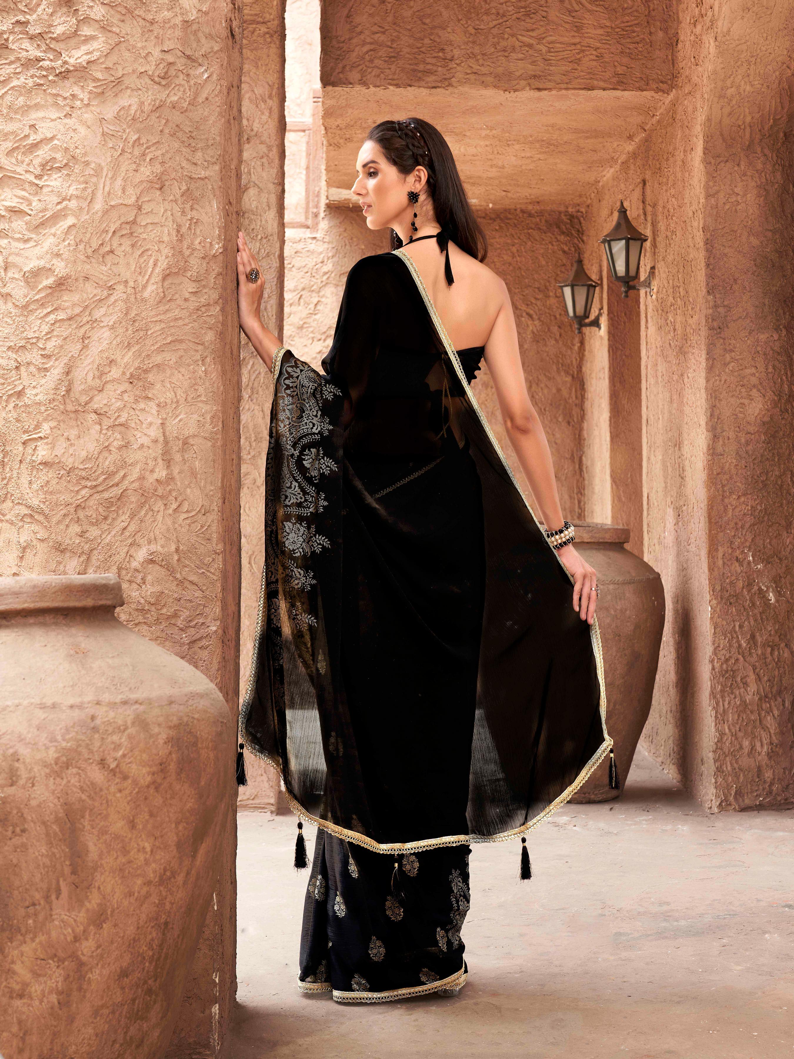 Black colored foil printed satin saree with embellished border
