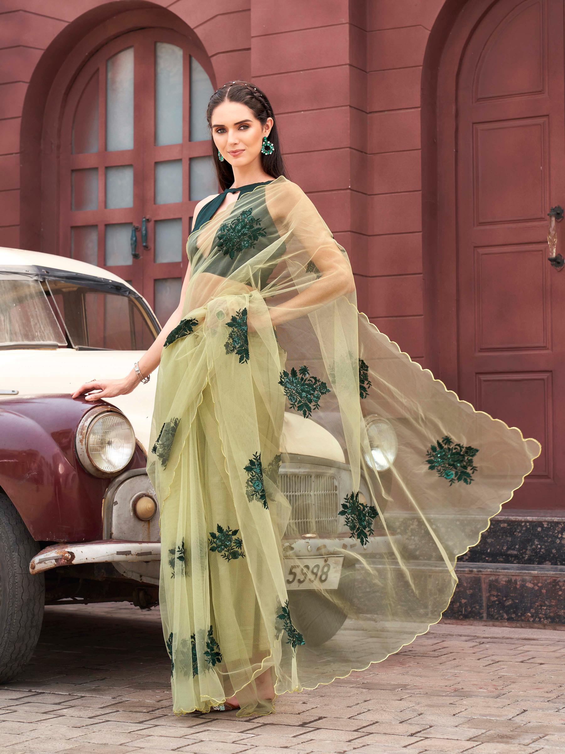 Green colored embroidered net saree with scalloped border