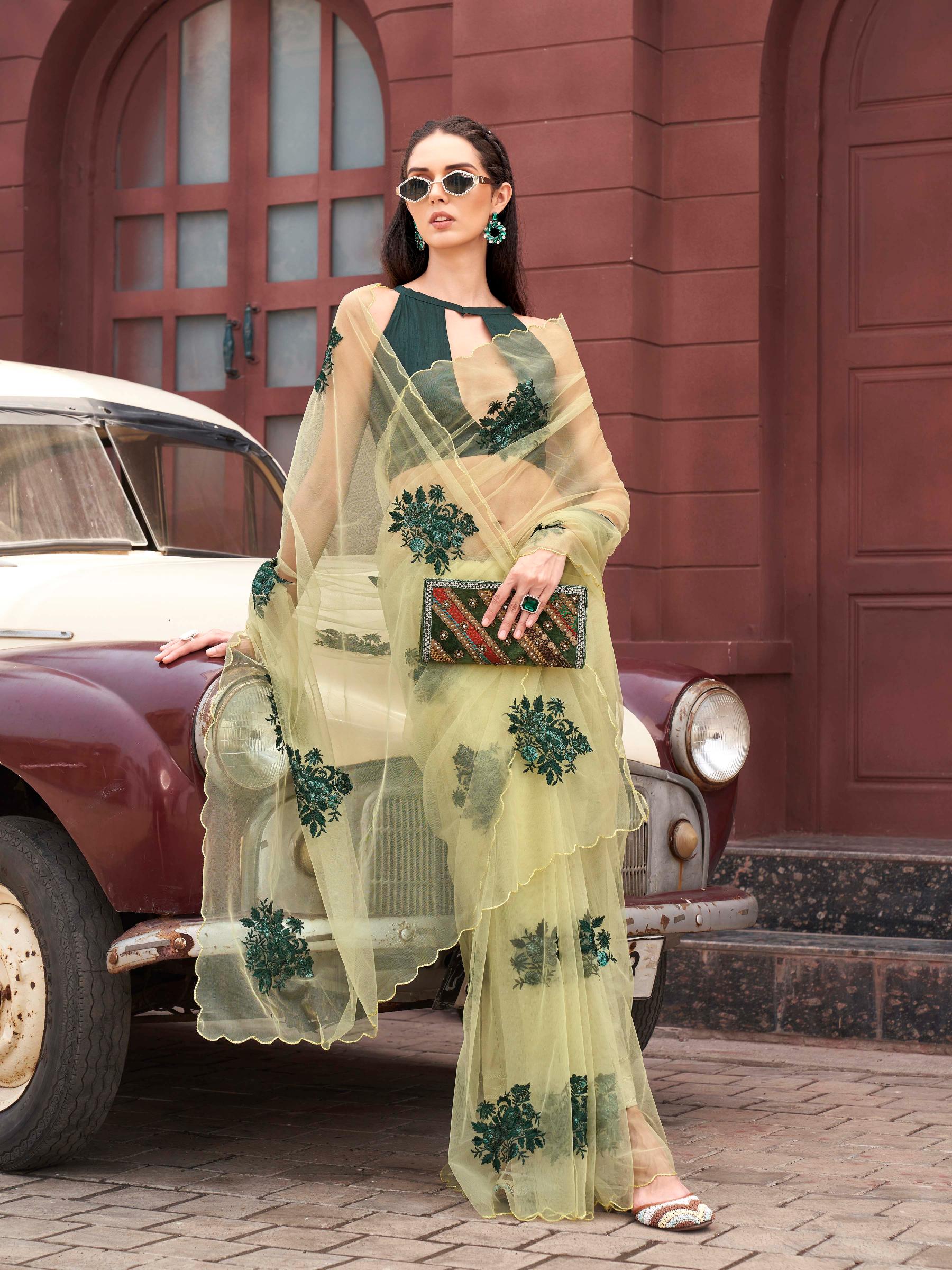 Green colored embroidered net saree with scalloped border