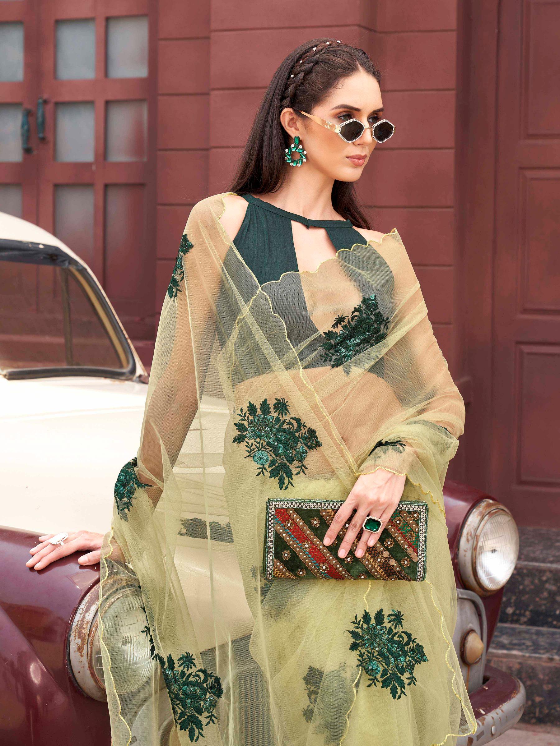 Green colored embroidered net saree with scalloped border