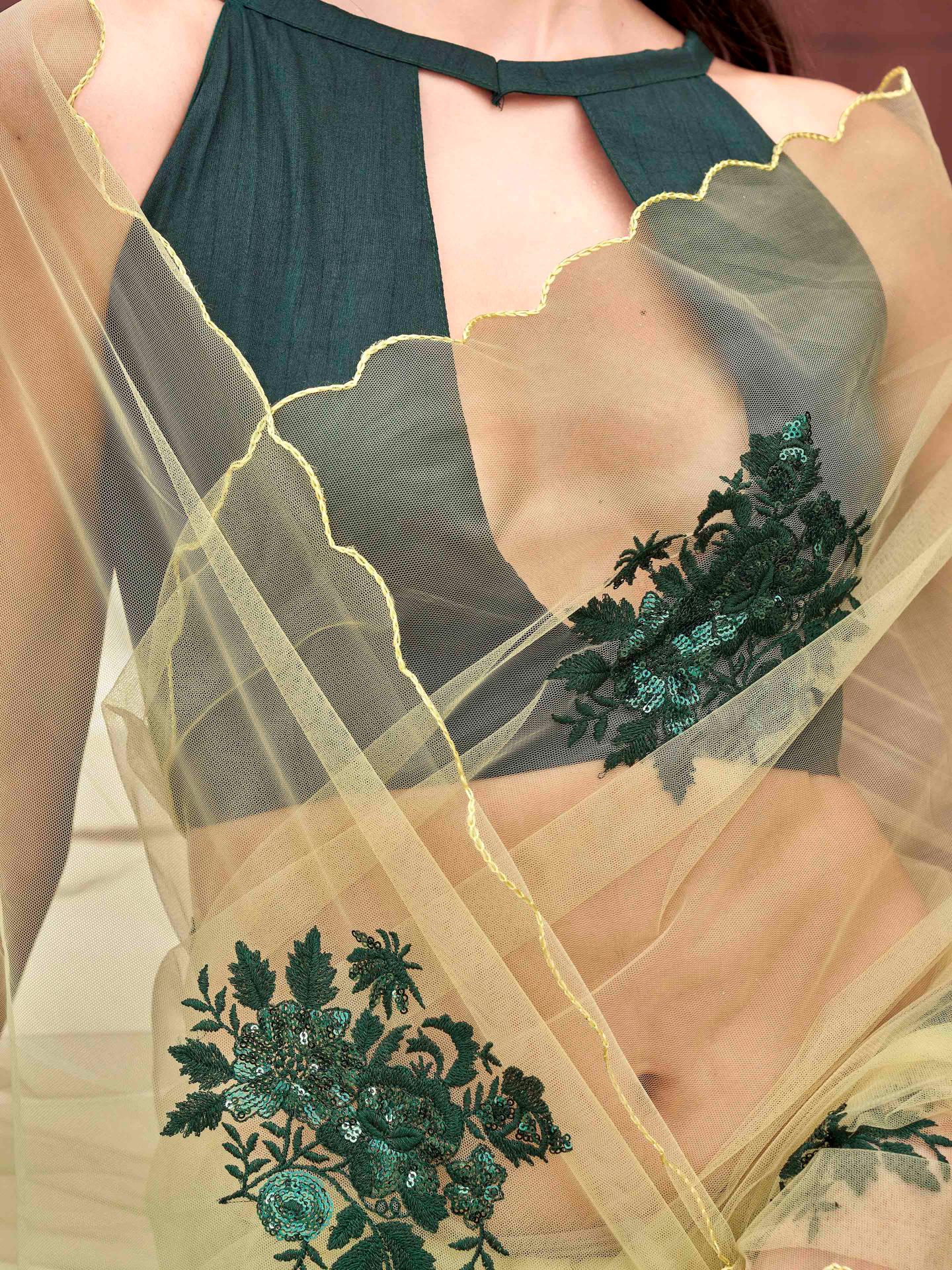 Green colored embroidered net saree with scalloped border