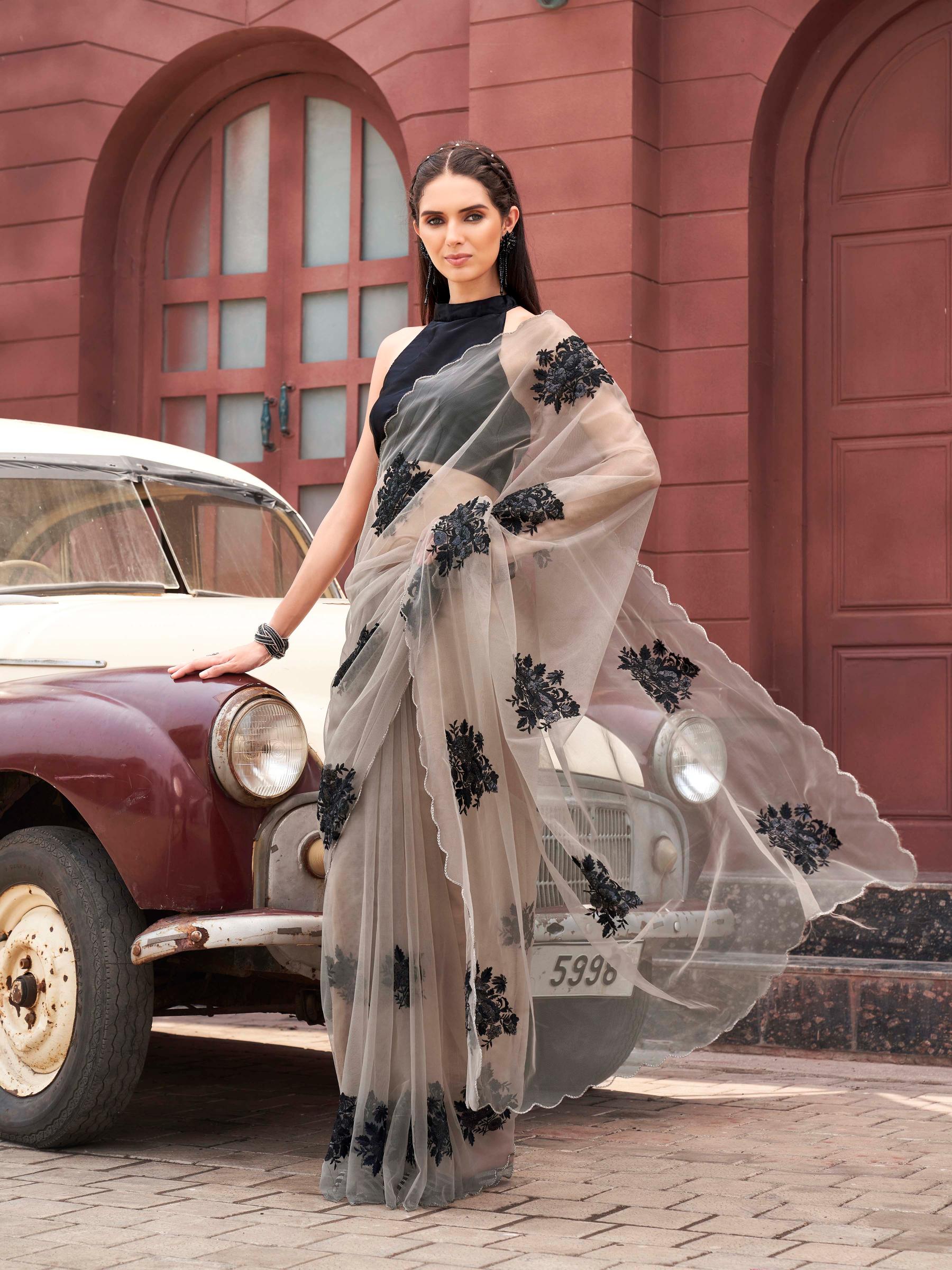 Tan colored embroidered net saree with scalloped border