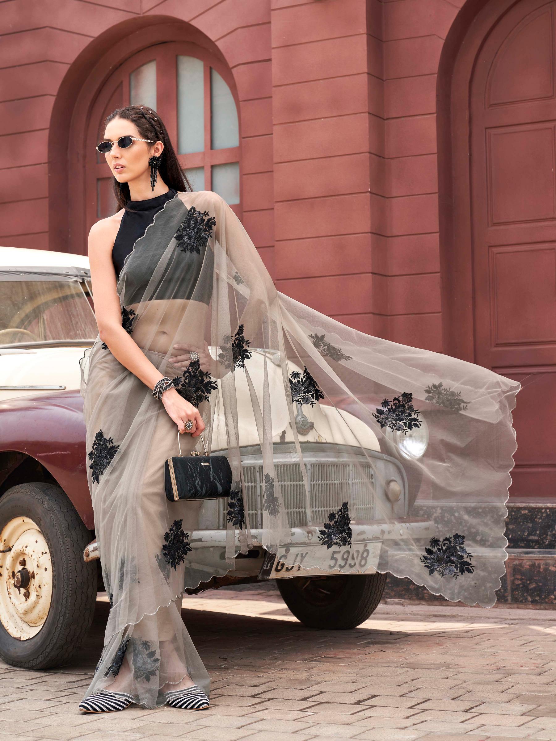 Tan colored embroidered net saree with scalloped border