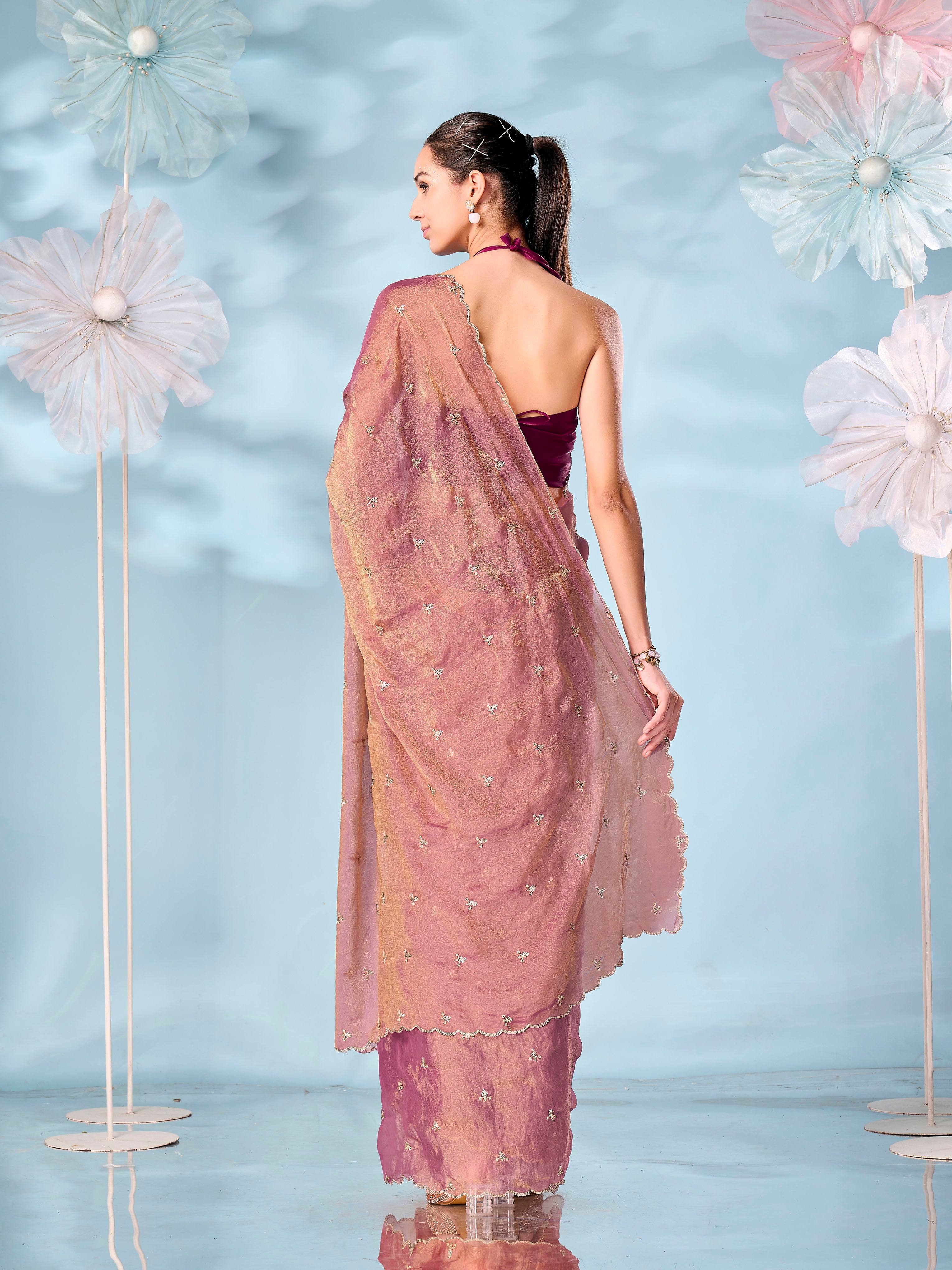 Rust colored sequinned butti shimmer saree with scalloped border