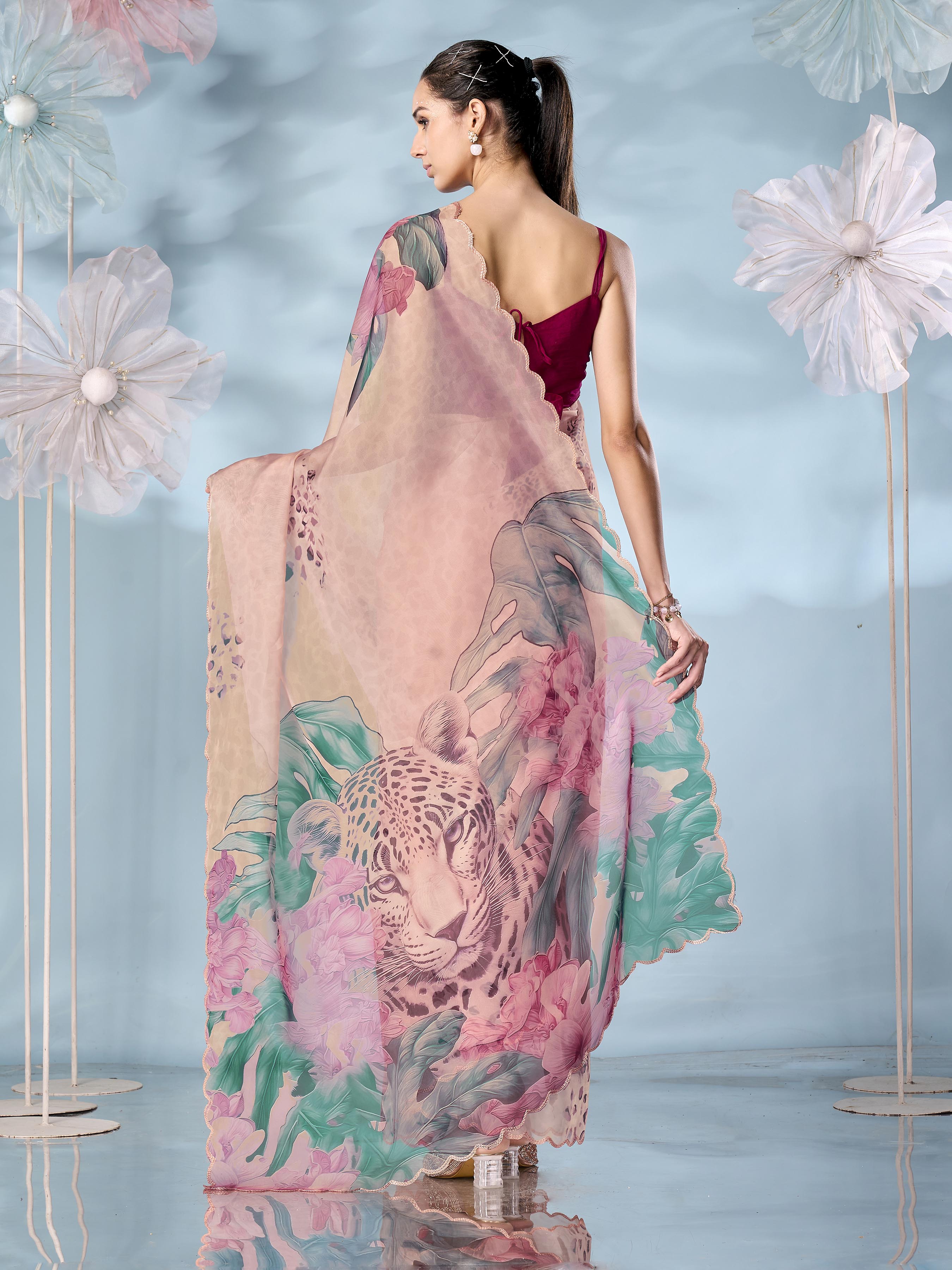 Peach colored designer animal print organza saree with scalloped border