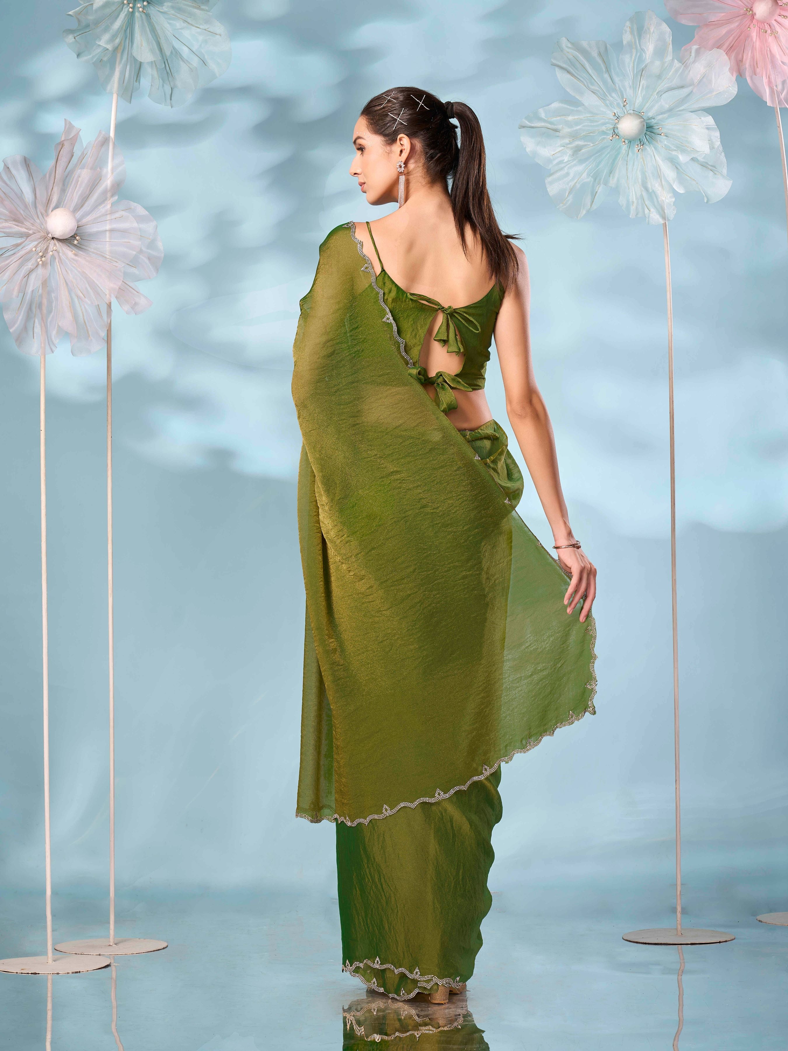 Two tone green and gold colored shimmer saree with swaroski border