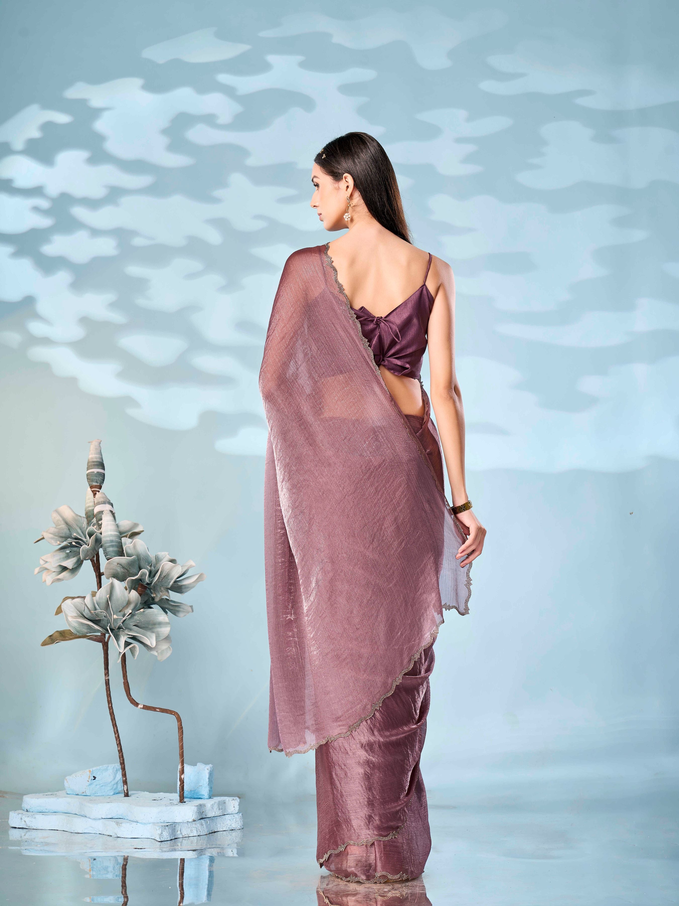 Mauve colored designer jimmy choo saree with swaroski border