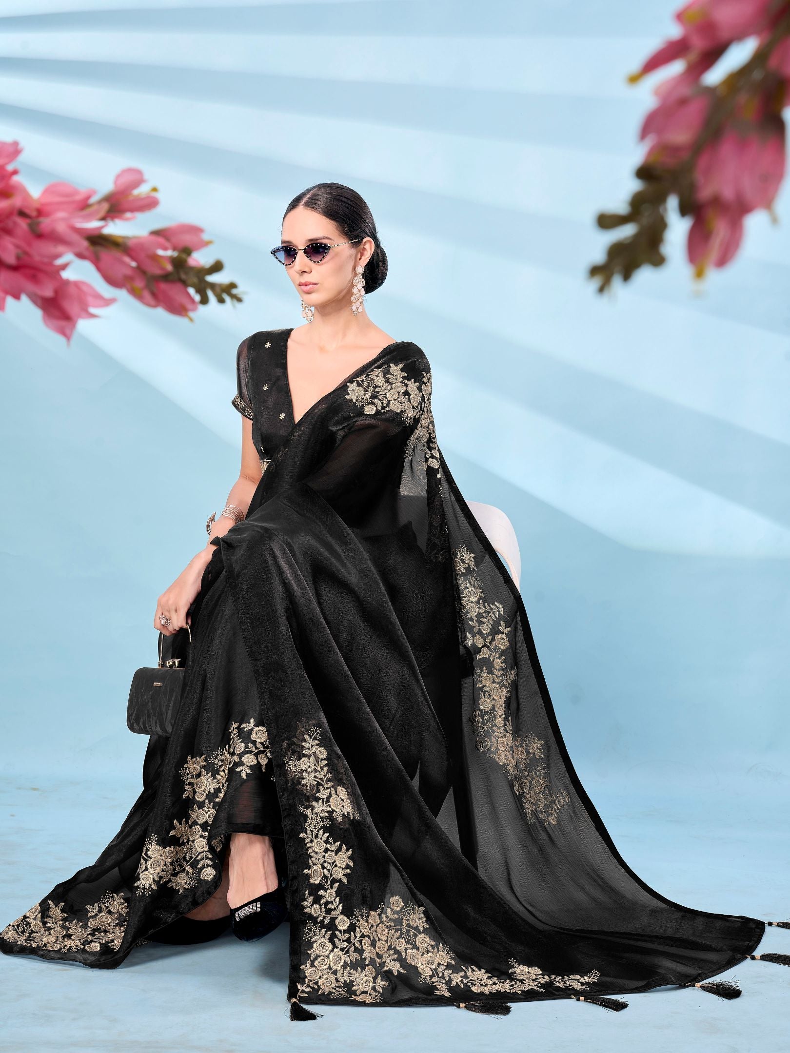 Black colored zari embroidered designer saree with tassles on pallu