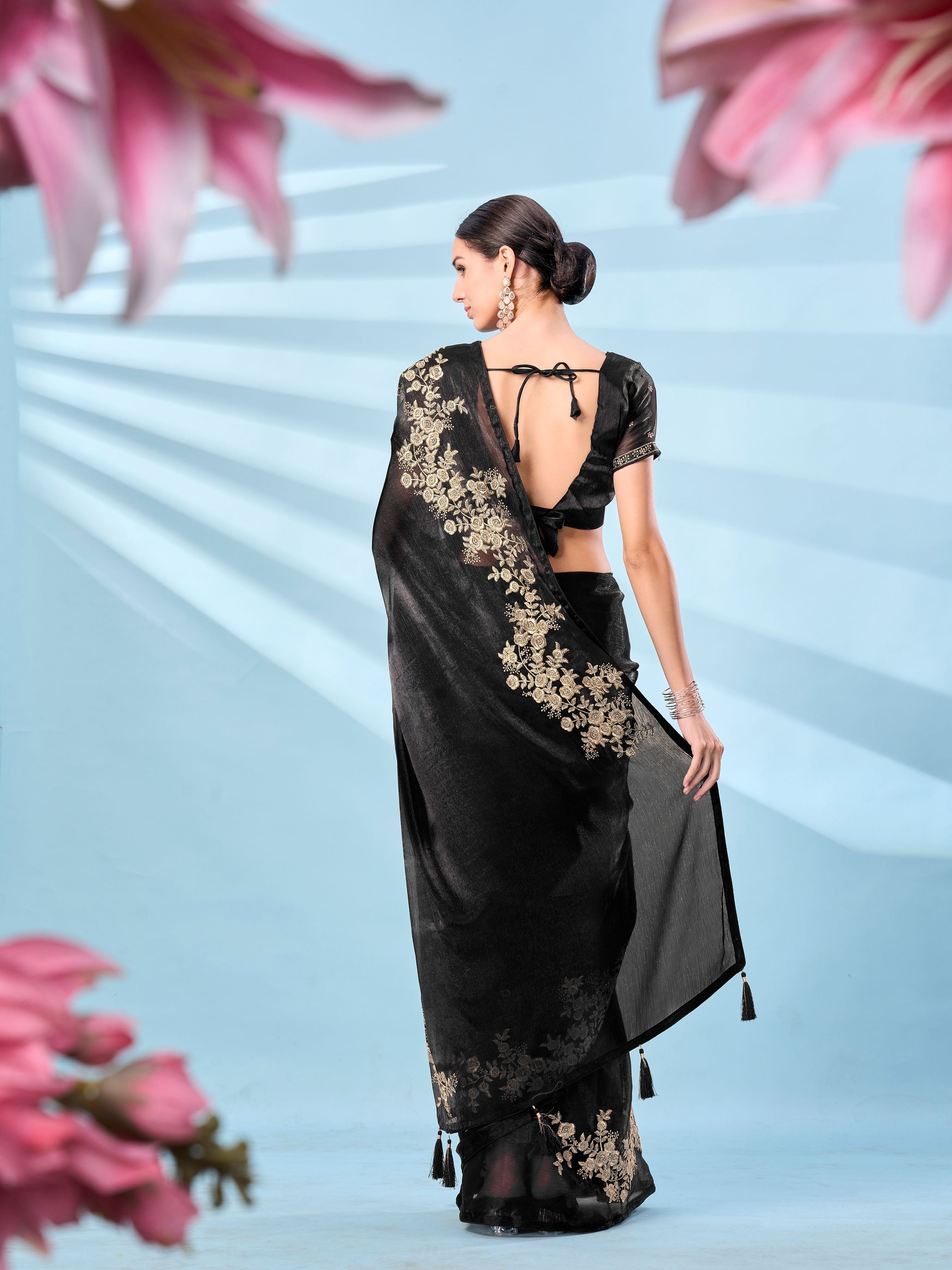 Black colored zari embroidered designer saree with tassles on pallu