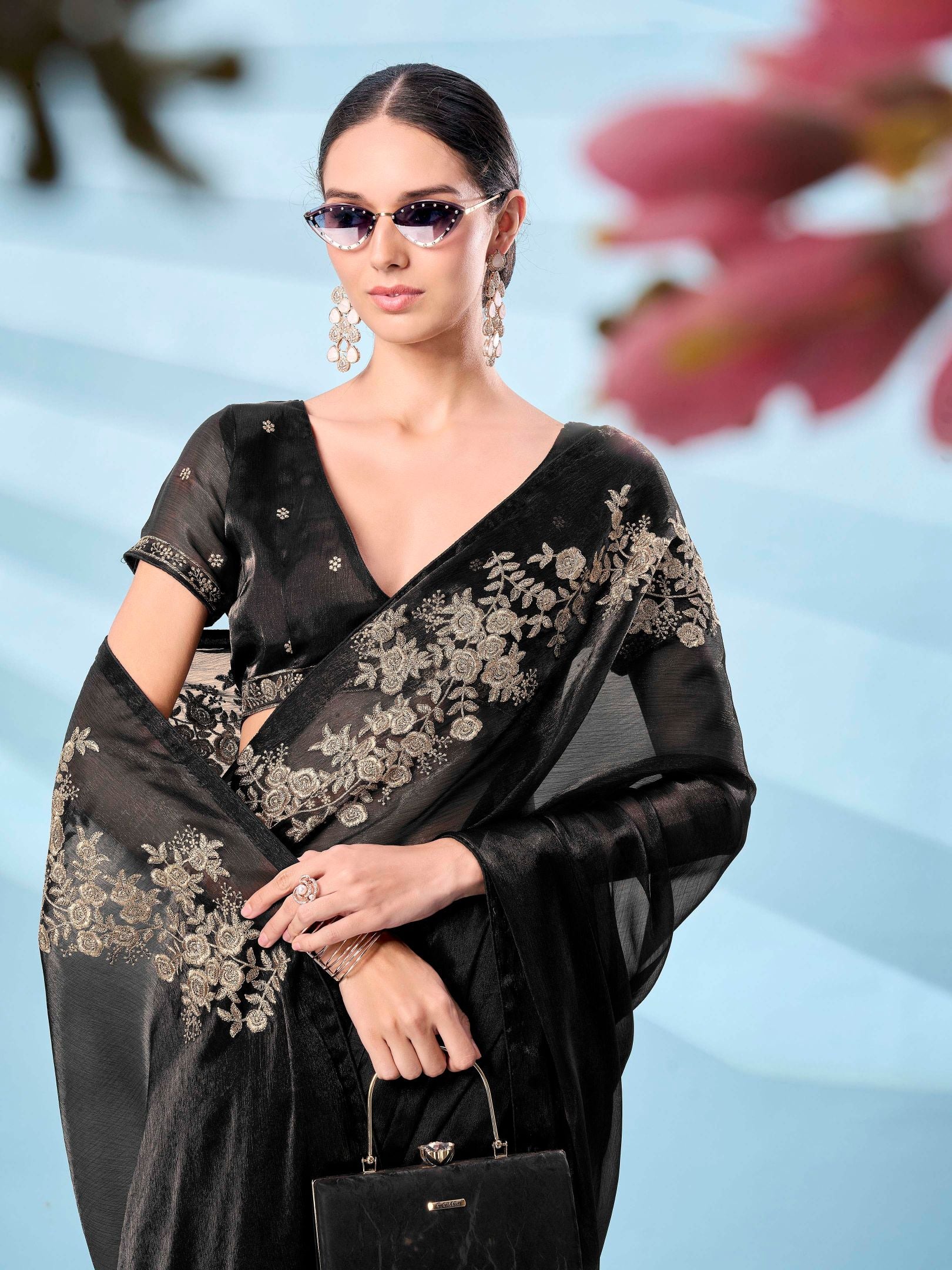 Black colored zari embroidered designer saree with tassles on pallu