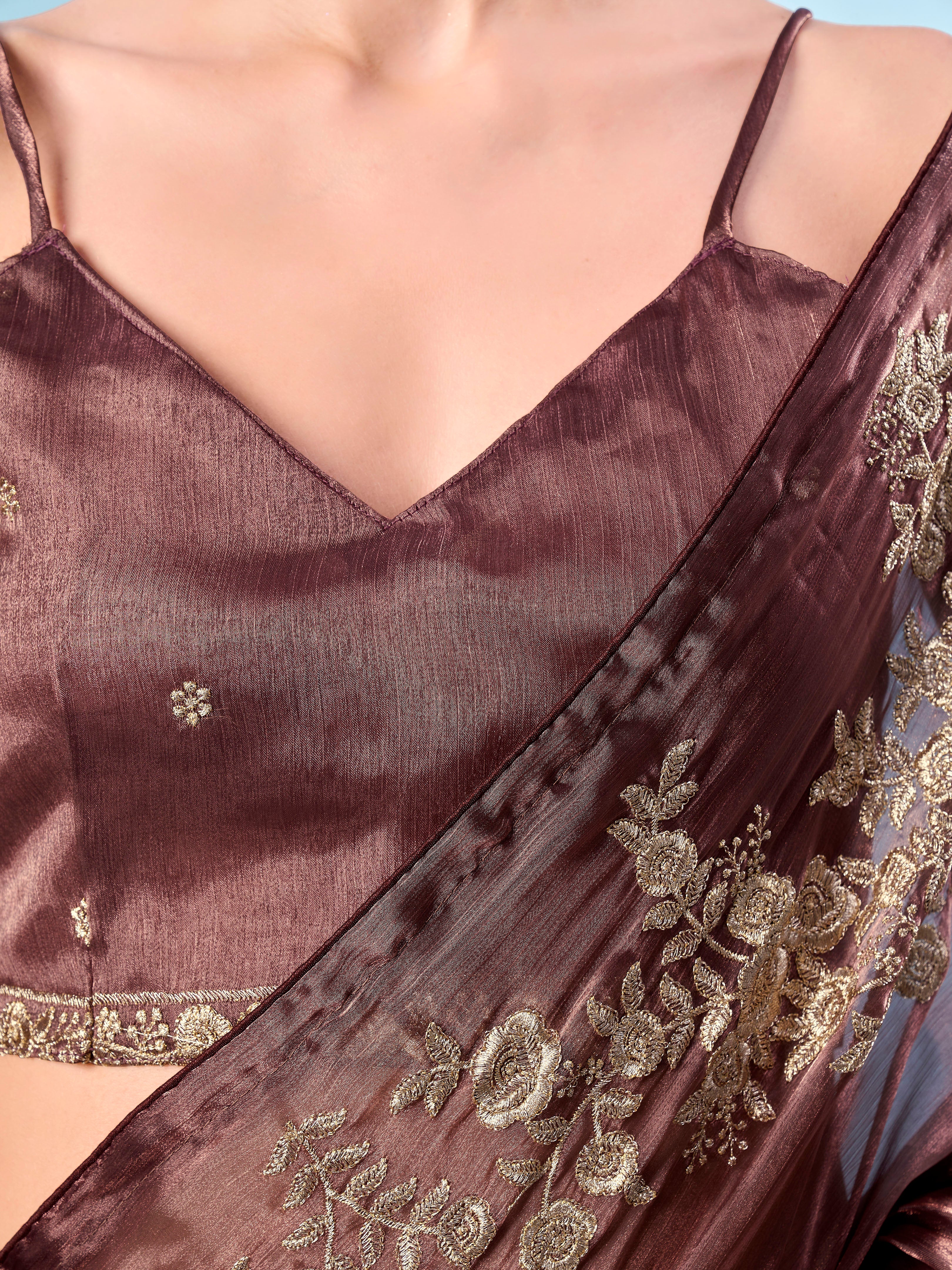 Metallic bronze colored zari embroidered saree with tassles on pallu