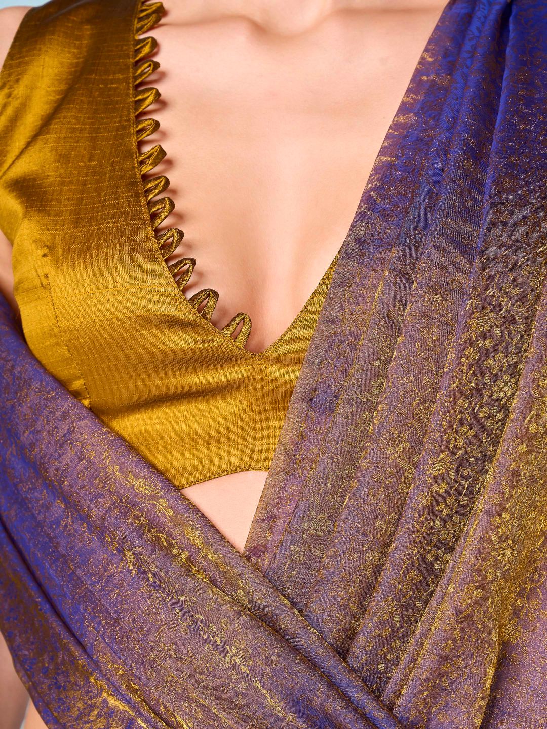Two tone purple and mustard colored woven saree with tassles on pallu