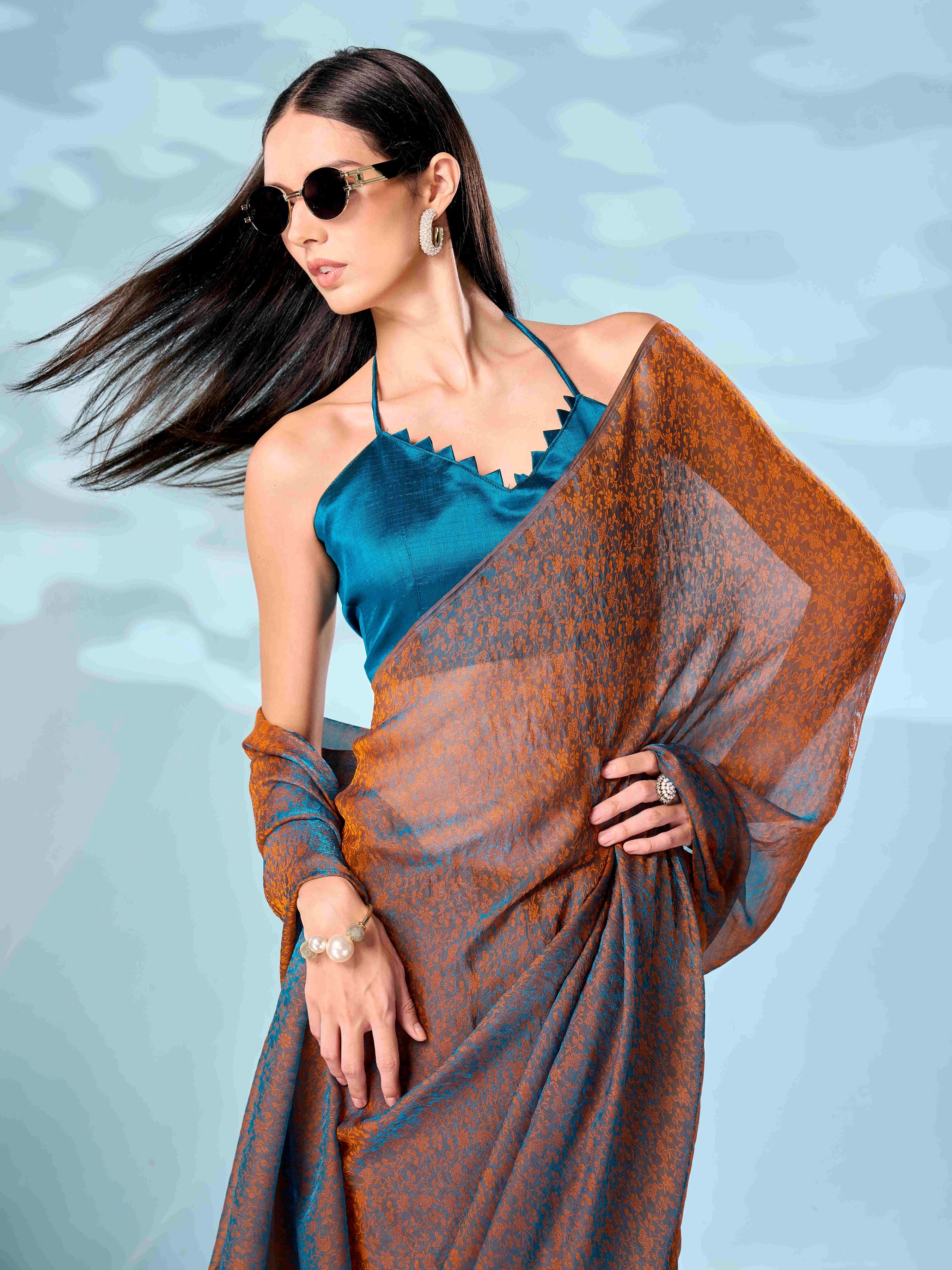 Two tone teal and orange colored woven saree with tassles on pallu