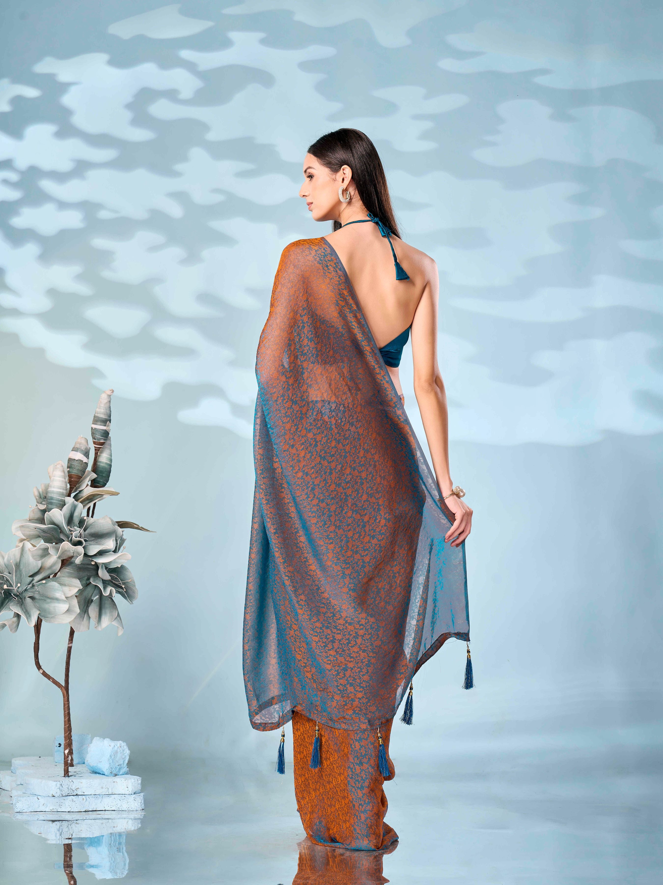 Two tone teal and orange colored woven saree with tassles on pallu