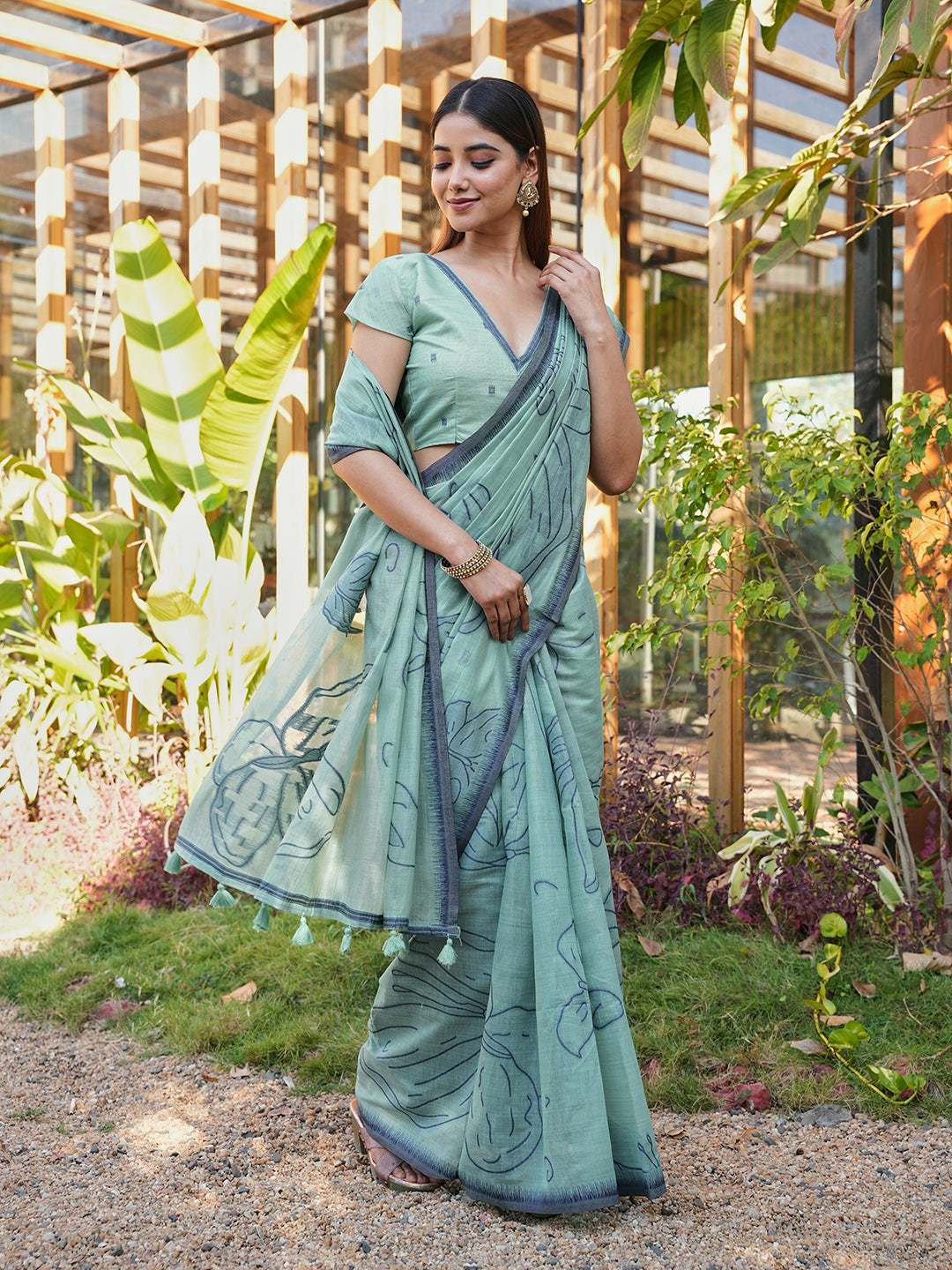 Blue colored muga cotton saree with tassles on pallu