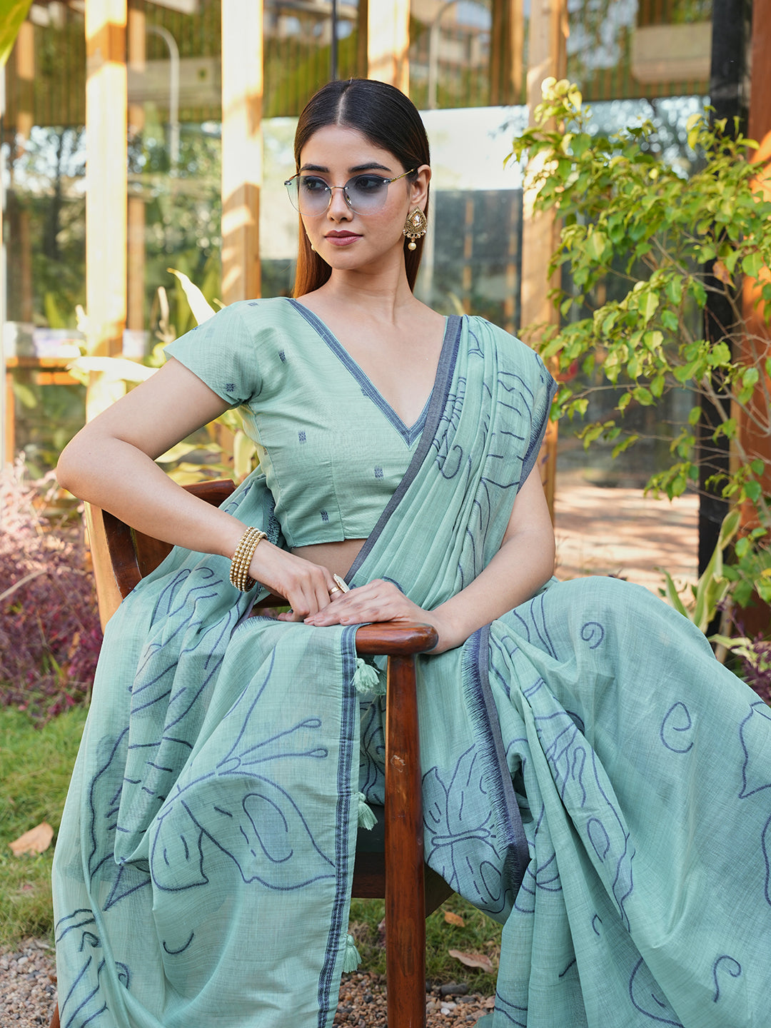 Blue colored muga cotton saree with tassles on pallu