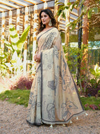 Beige colored muga cotton saree with tassles on pallu