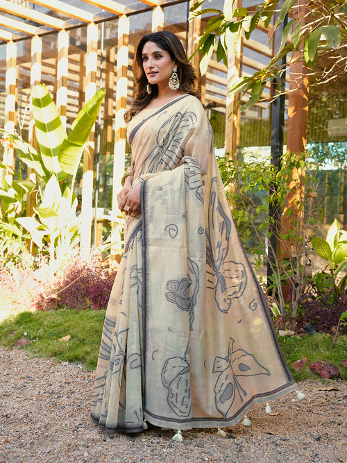 Beige colored muga cotton saree with tassles on pallu