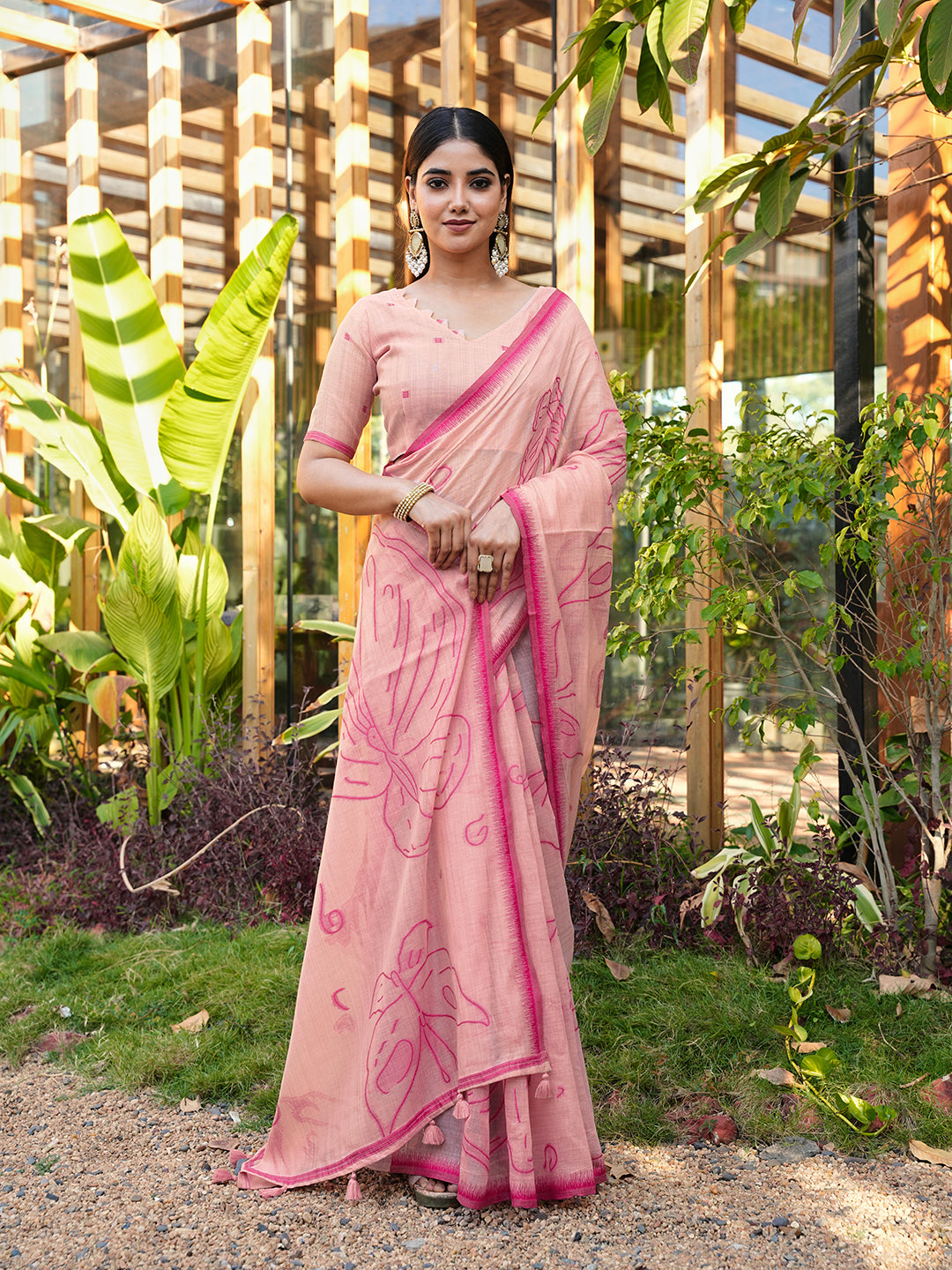 Pink colored muga cotton saree with tassles on pallu