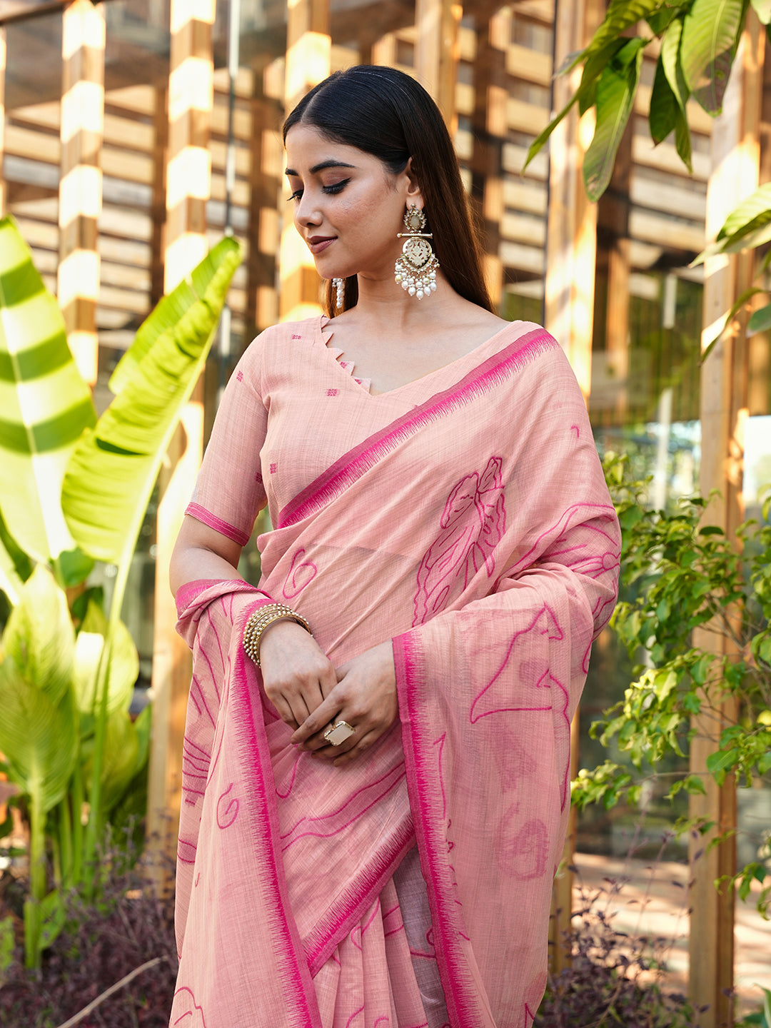 Pink colored muga cotton saree with tassles on pallu