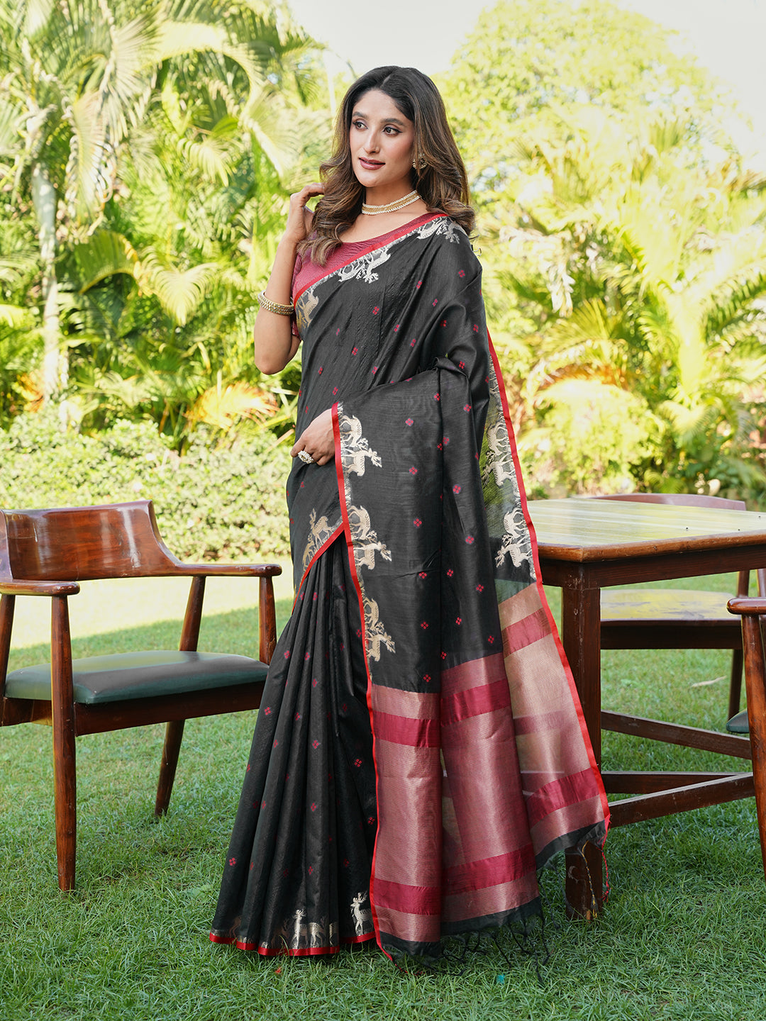 Black and red colored raw silk saree with tassles on pallu